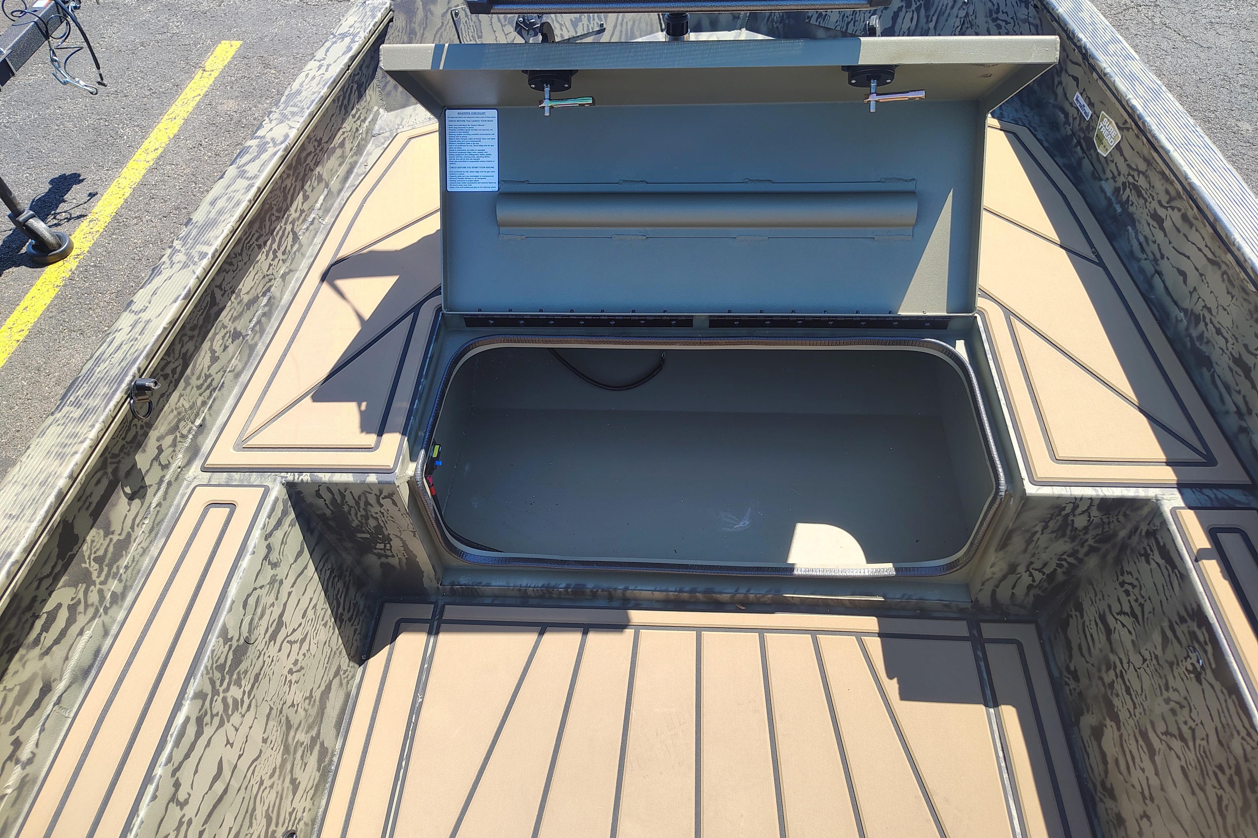 2026 Tracker Grizzly 1650 T Prairie Wings Edition boat interior with open storage compartment.