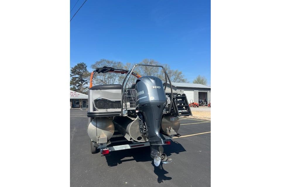 2024 Bennington 23 RXFBA pontoon boat with Yamaha 300 outboard motor, parked outdoors.