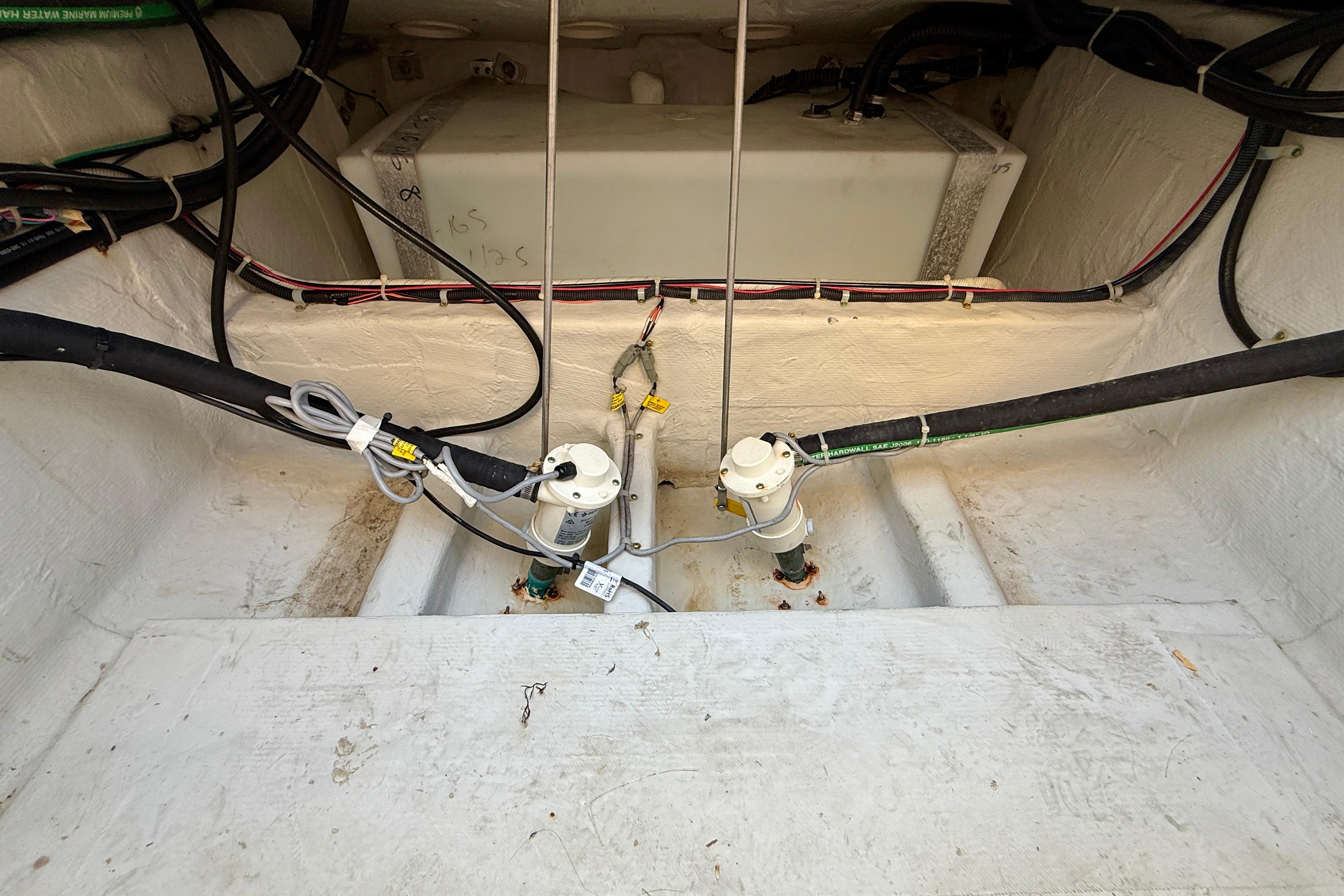 Bilge area of a 2012 Grady-White Canyon 336 boat, showing pumps and wiring.