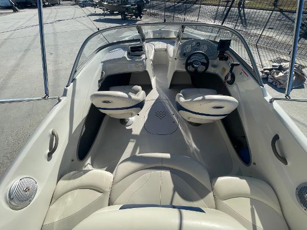 2012 Tahoe Q4 SS boat interior with white seating and steering console.