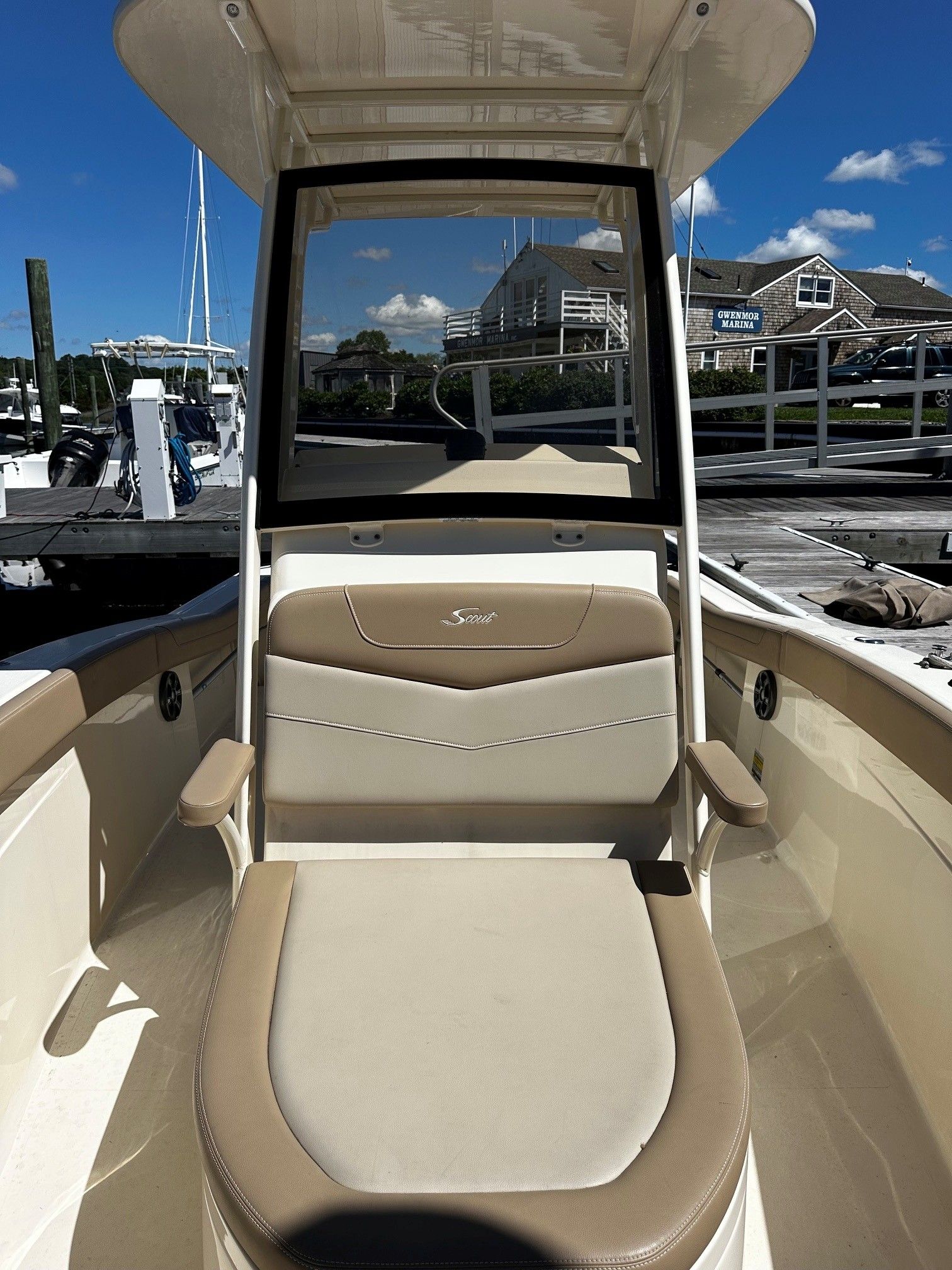 Scout 210XSF boat, 2022, docked with blue sky.