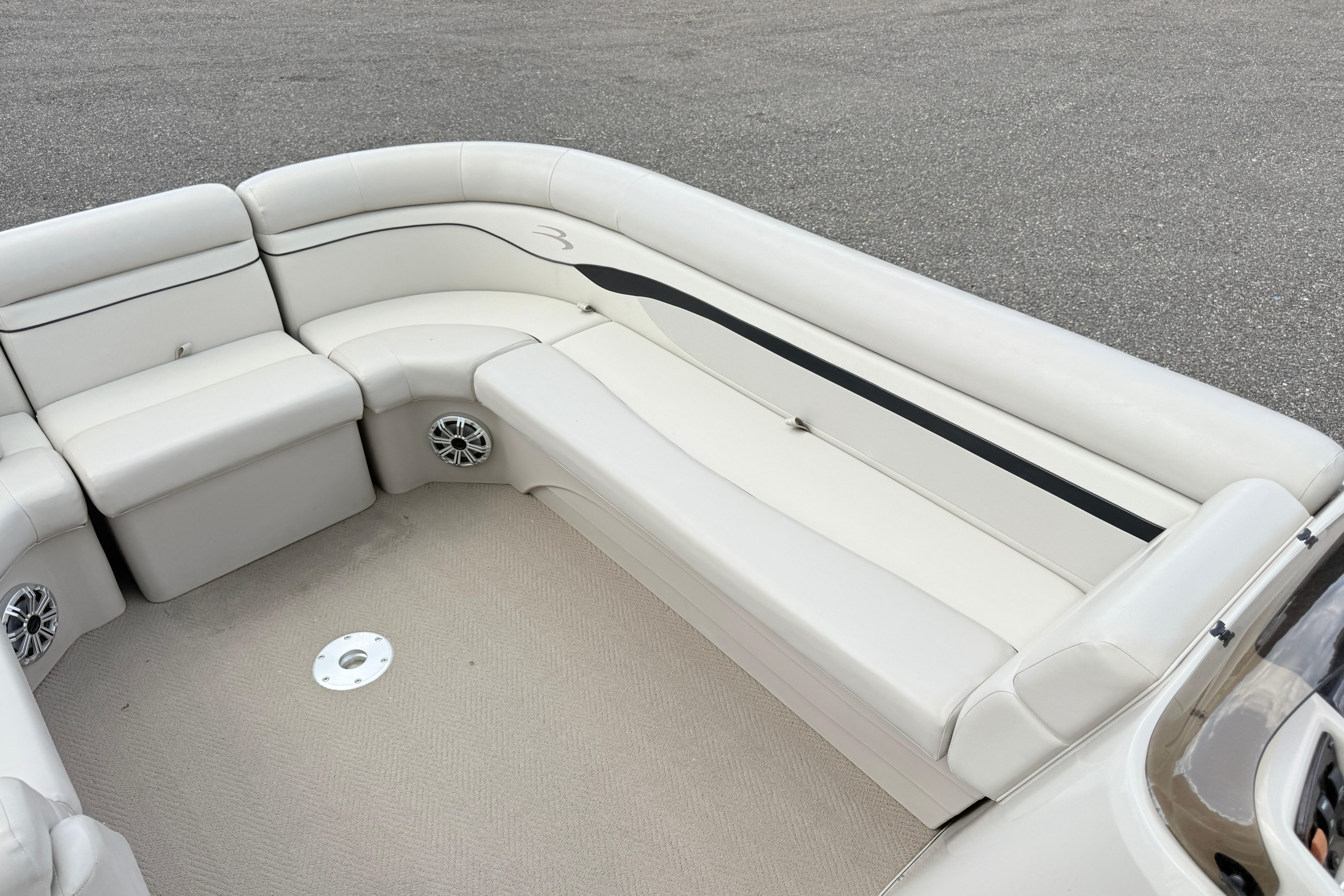 2015 Bennington 24SSLX boat interior with white seating and speaker system.