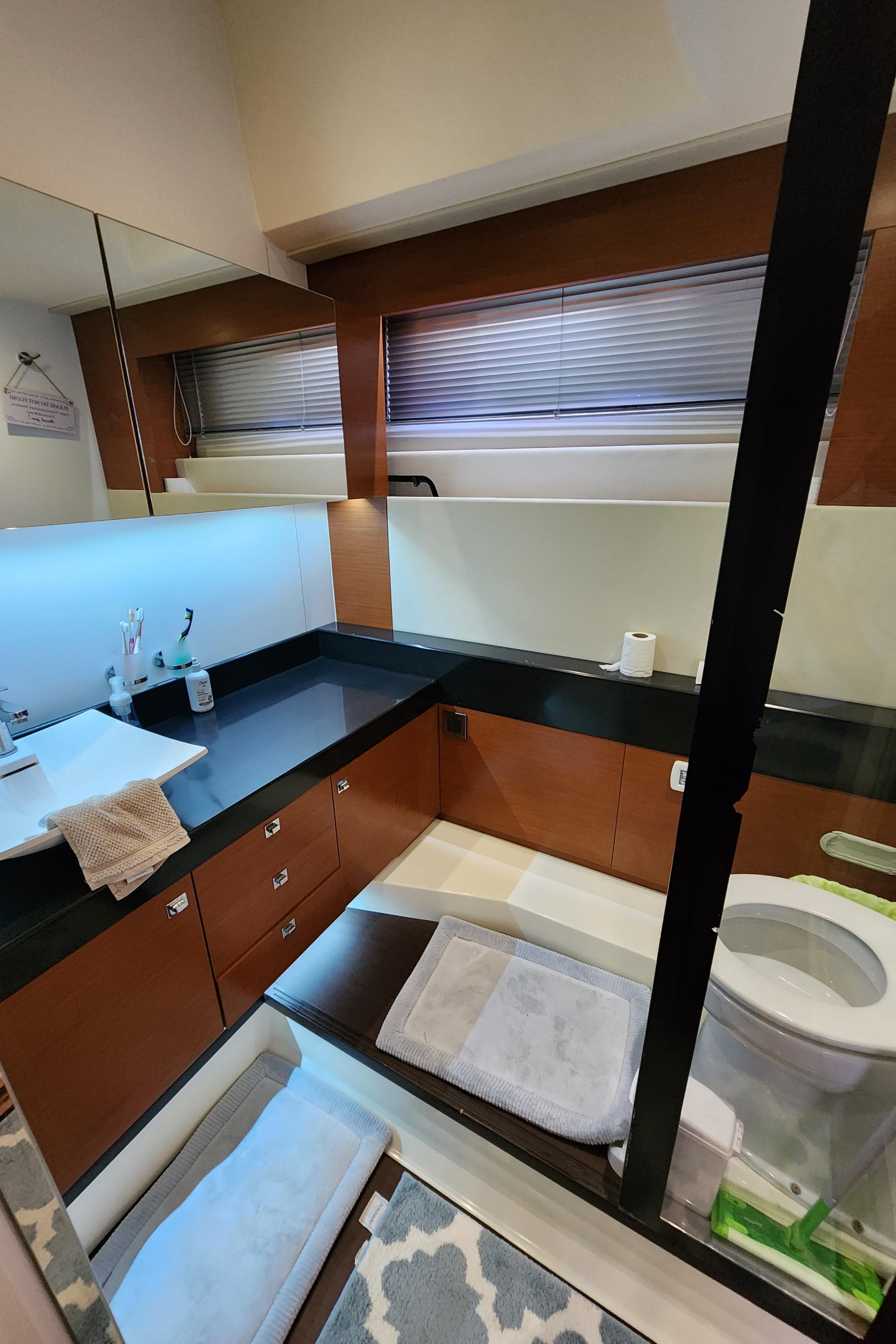 Luxurious bathroom in a 2014 Prestige 550 Fly yacht with modern fixtures and elegant design.