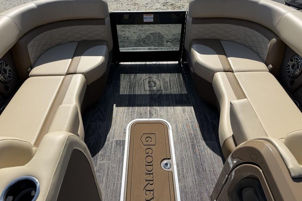 Luxurious interior of 2026 Godfrey Monaco 235 SB pontoon boat with beige seating.