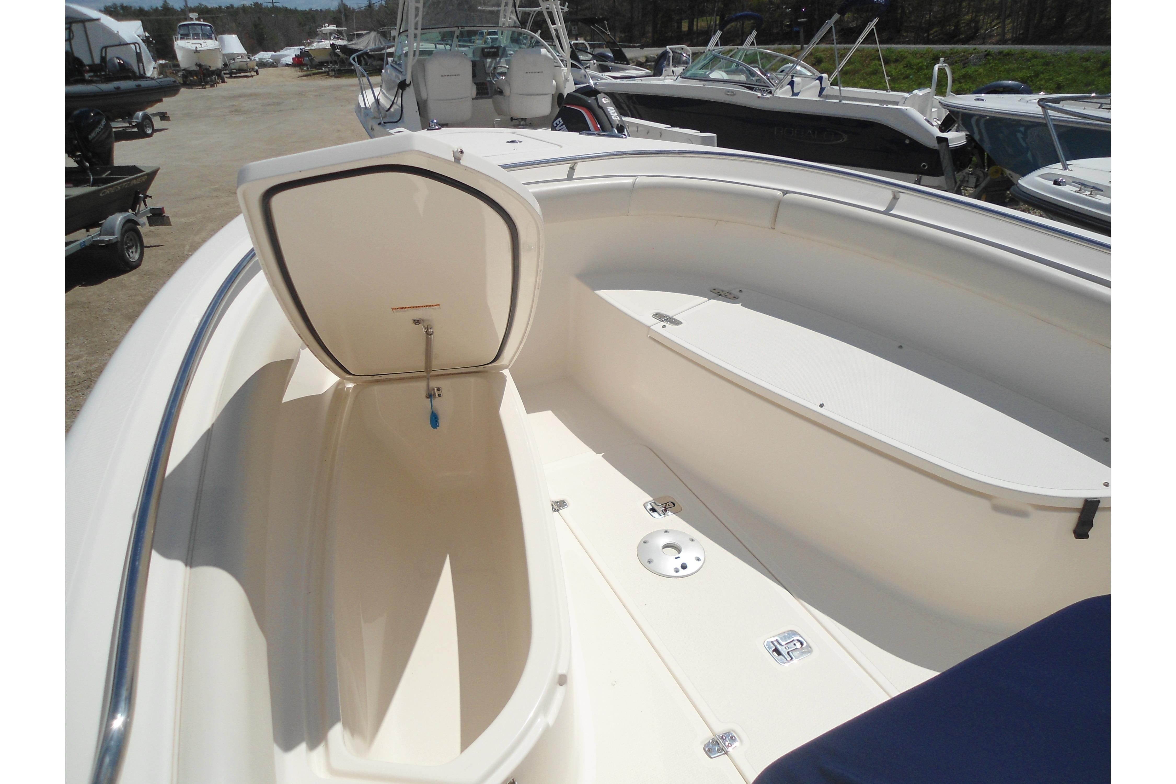 2013 Pursuit C 260 Center Console boat with open storage compartment.