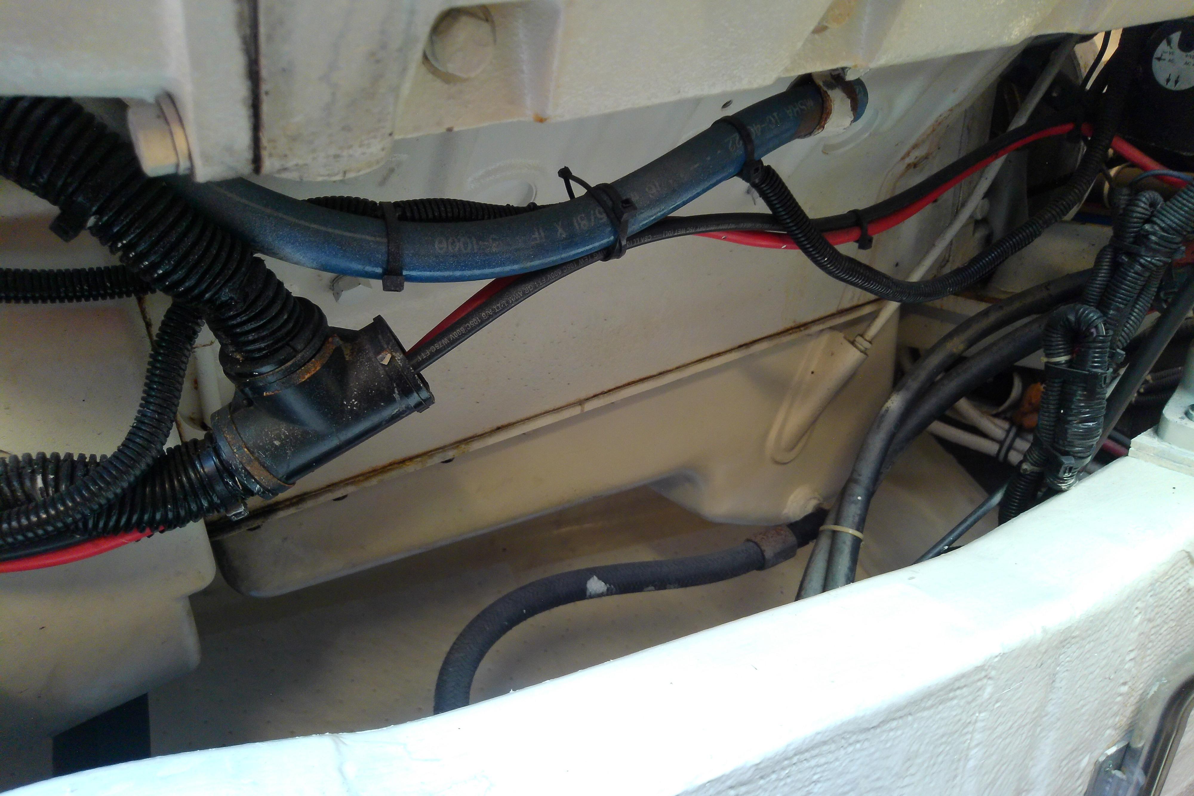 Engine compartment of a 2000 Tiara Yachts 4100 Open, showing wiring and hoses.