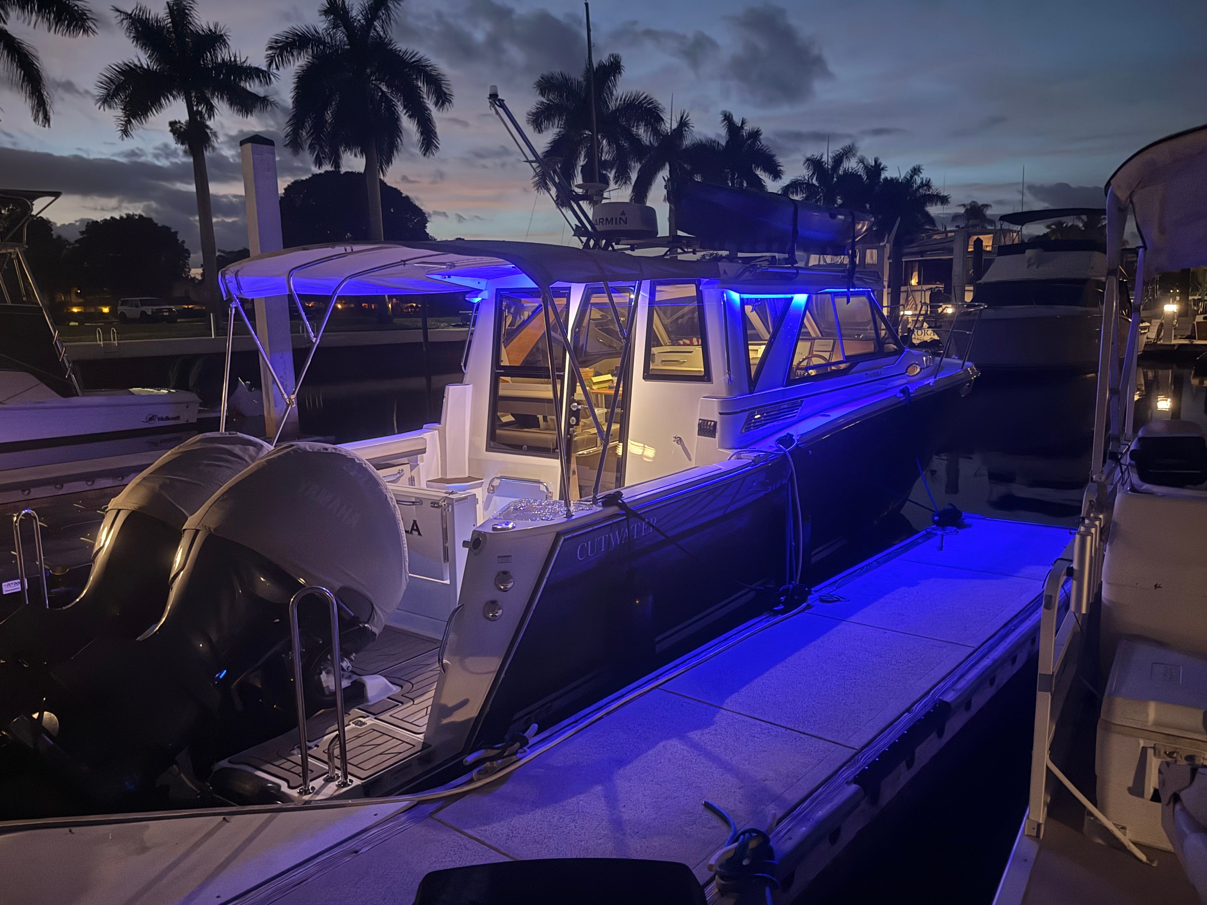 2023 Cutwater C-228 at night with blue lighting at the dock.