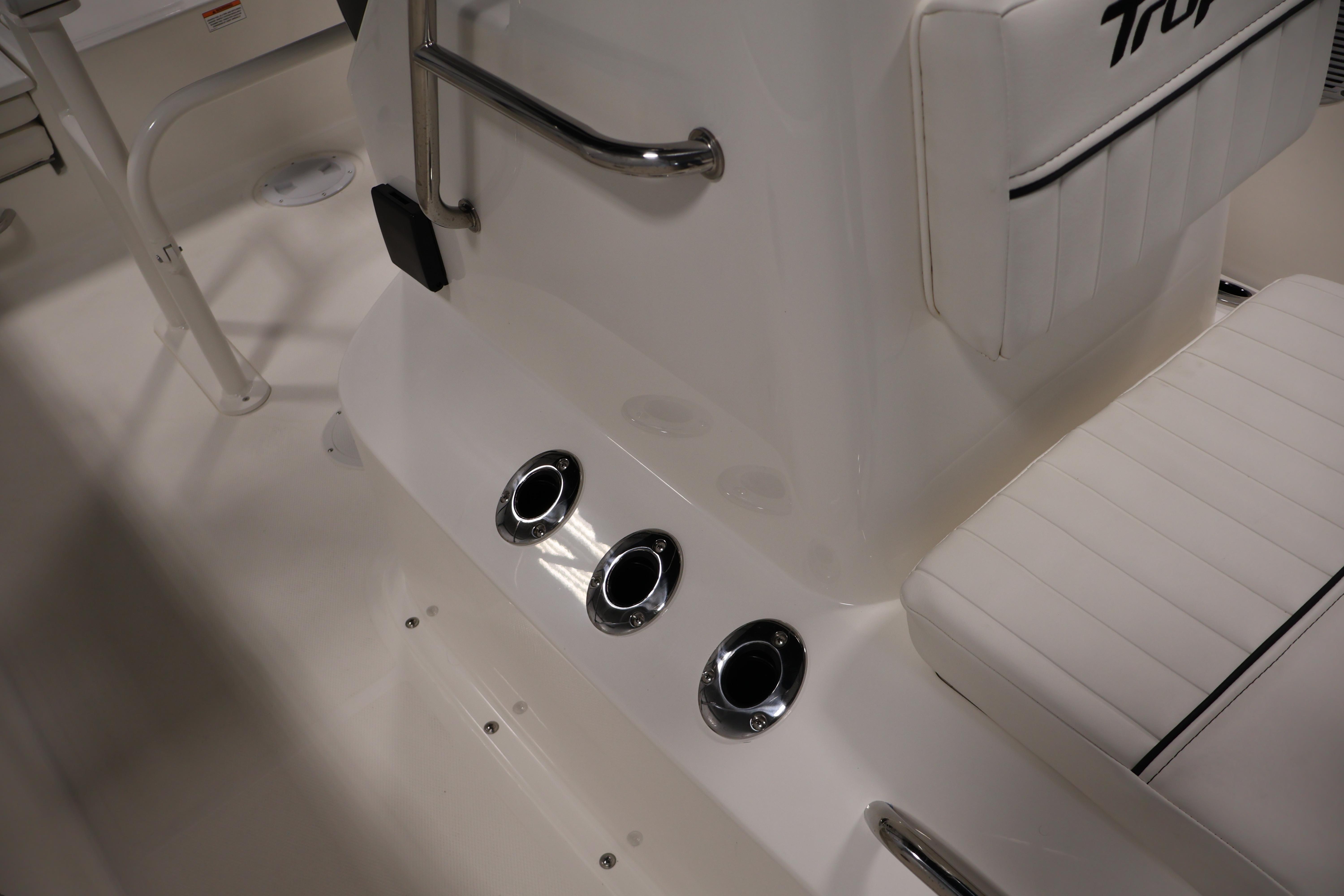 Interior view of 2026 Bayliner Trophy T18 boat, featuring white seating and chrome accents.