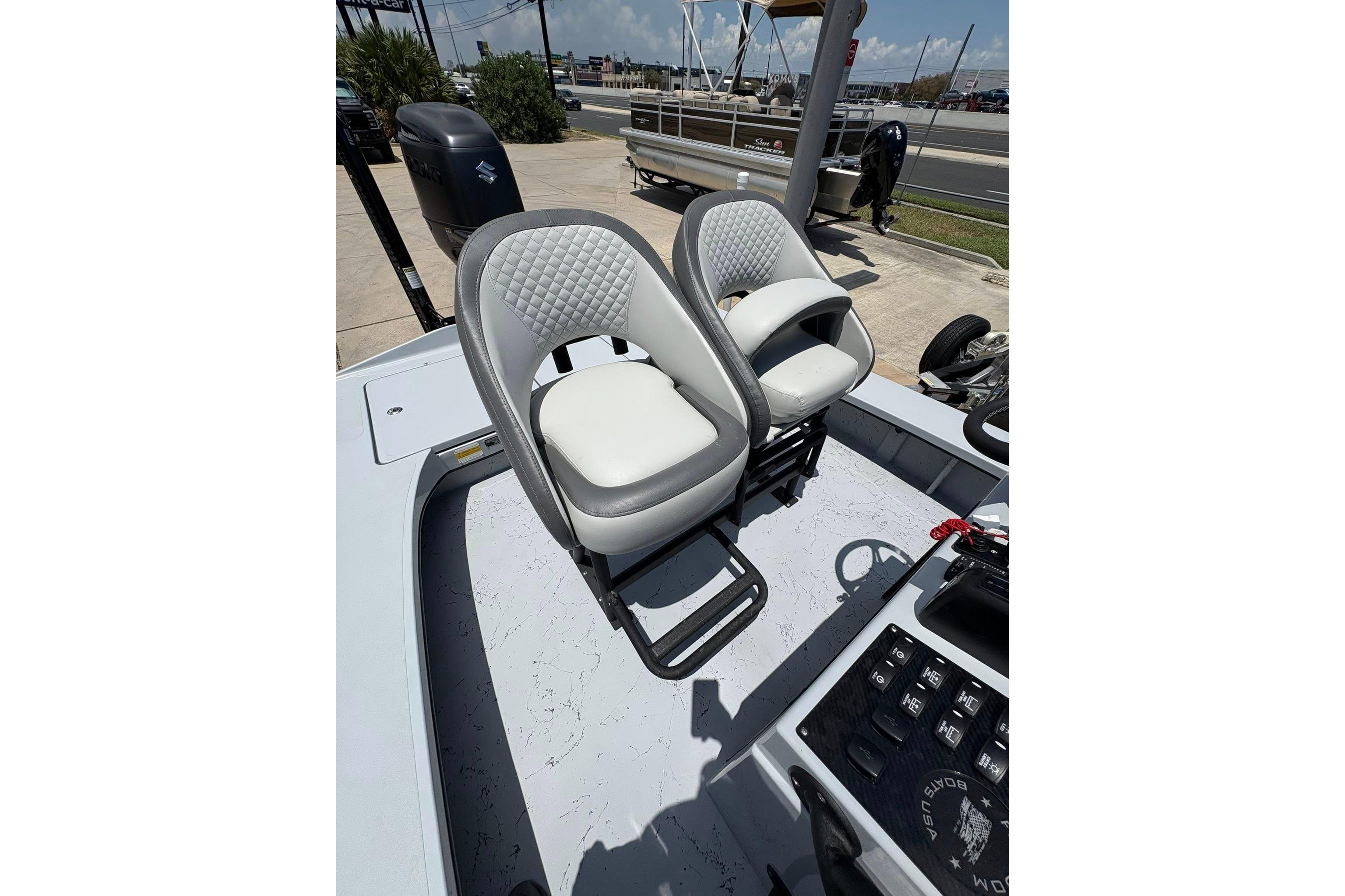 2026 Freedom Boats 23' Warrior interior with dual cushioned seats and control panel.