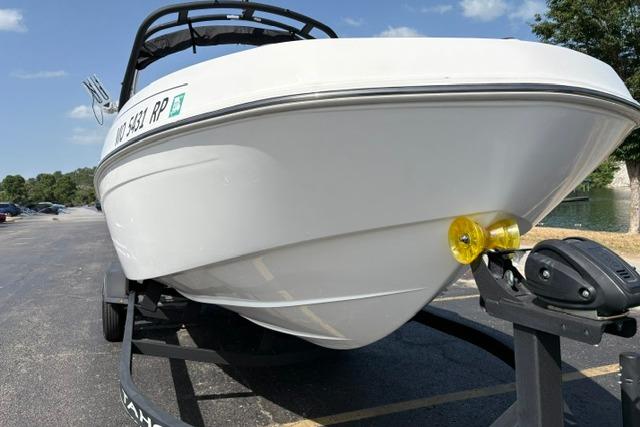 2024 Tahoe T21 boat on trailer in parking lot, sunny day.