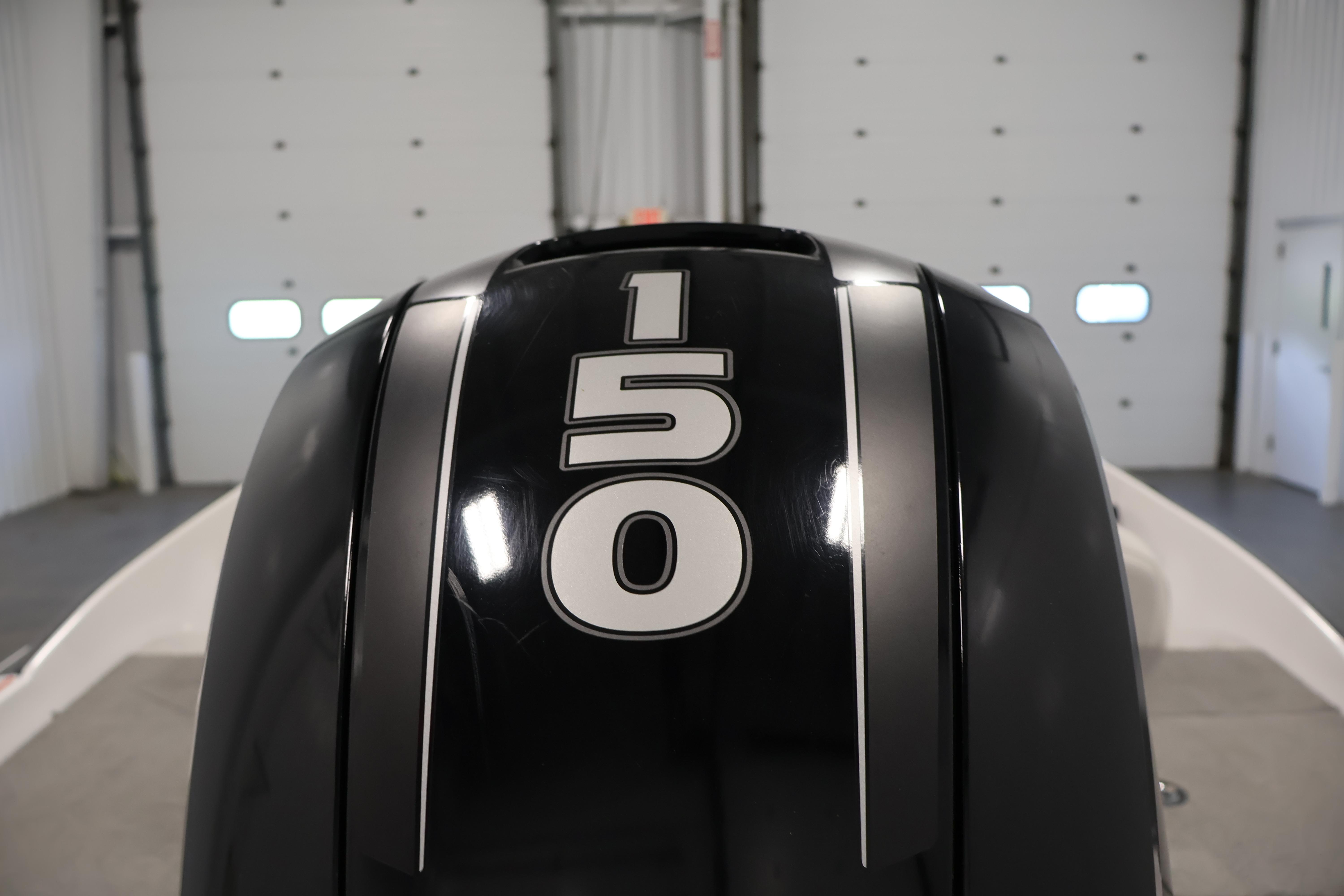2019 Nitro Z19 Sport boat engine with "150" horsepower label in a garage setting.
