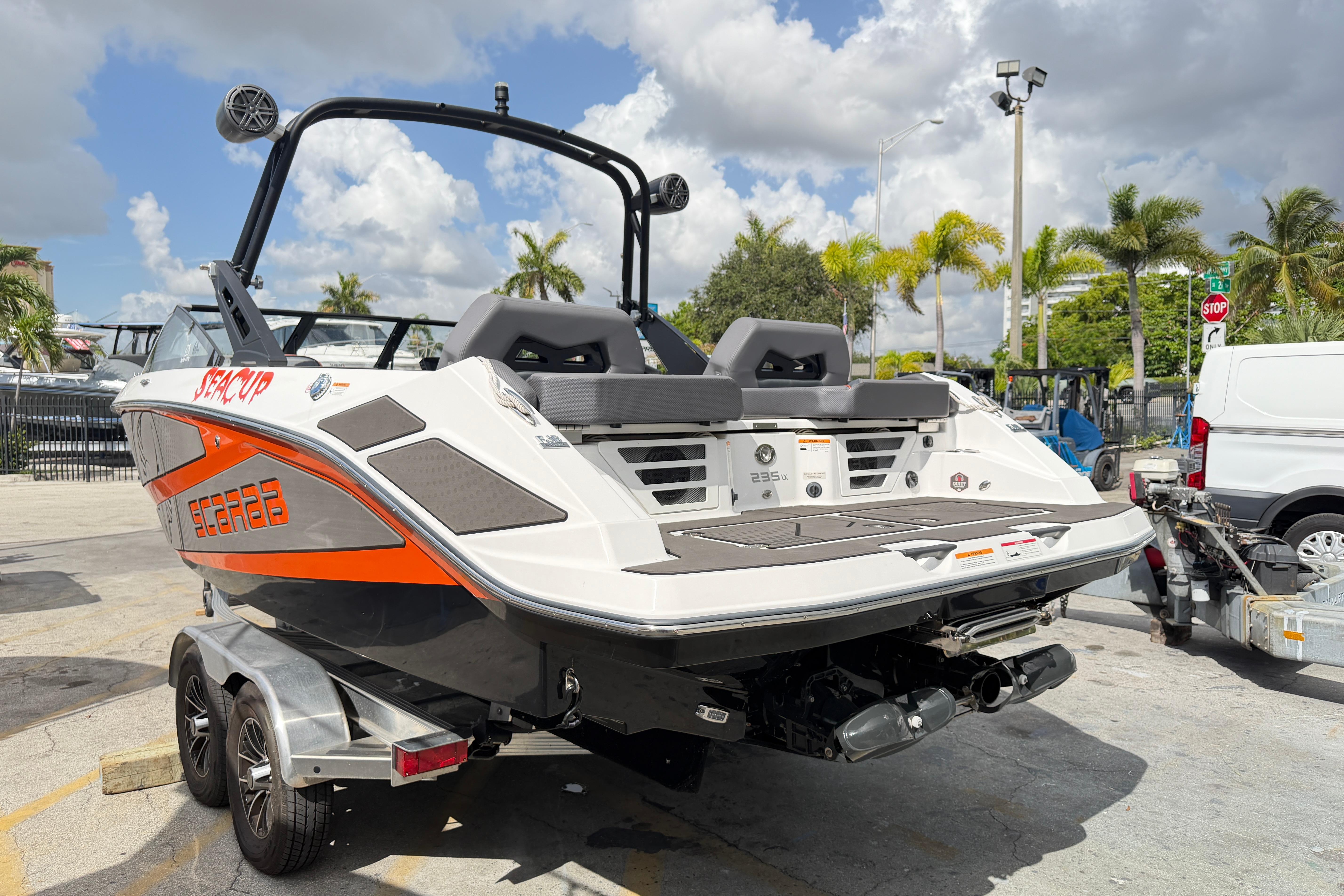 2026 Scarab 235 LX boat on trailer, parked outdoors under a cloudy sky.