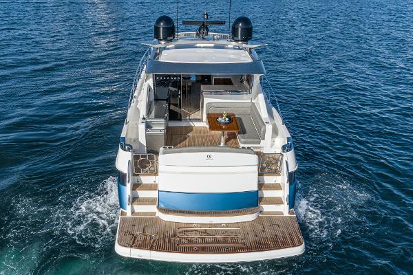 2021 Riviera 5400 Sport Yacht on open water, rear view.