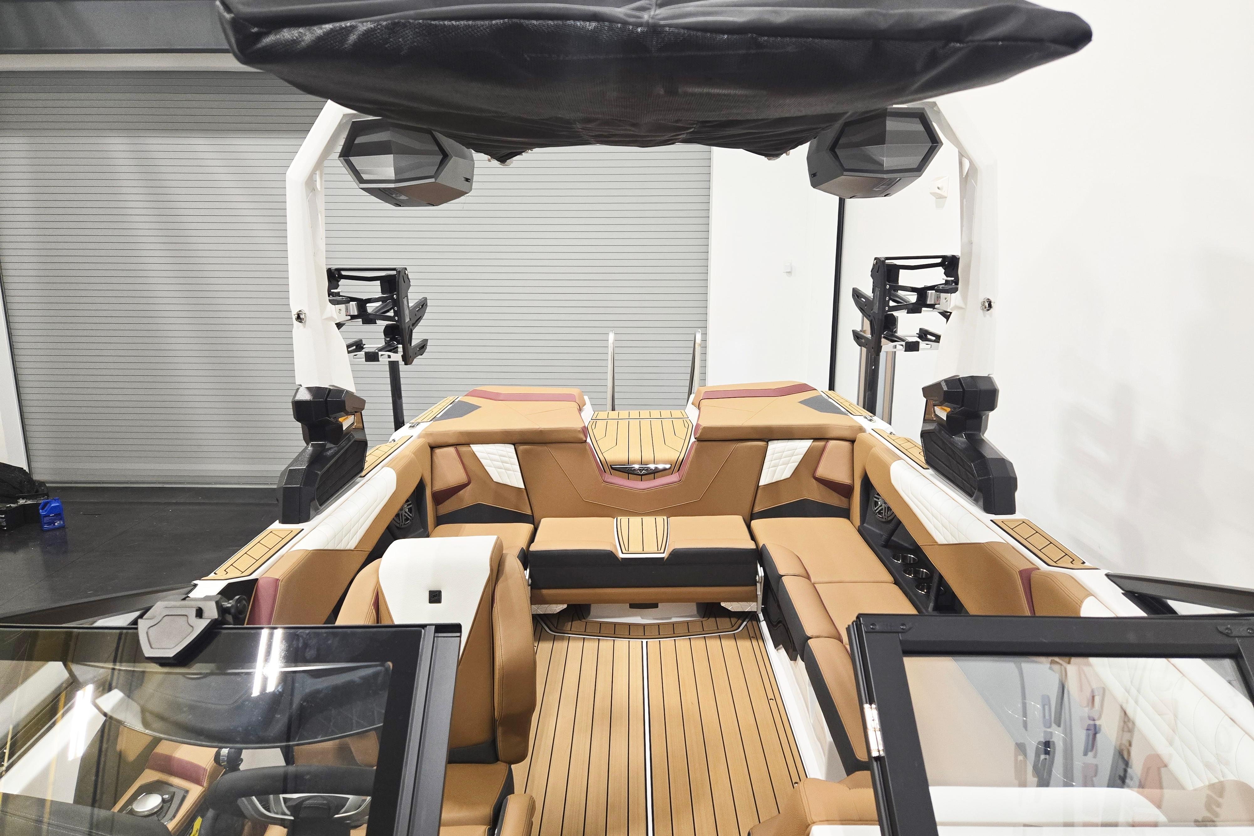 2026 Nautique Super Air Nautique S23 interior with tan seating and advanced audio system.
