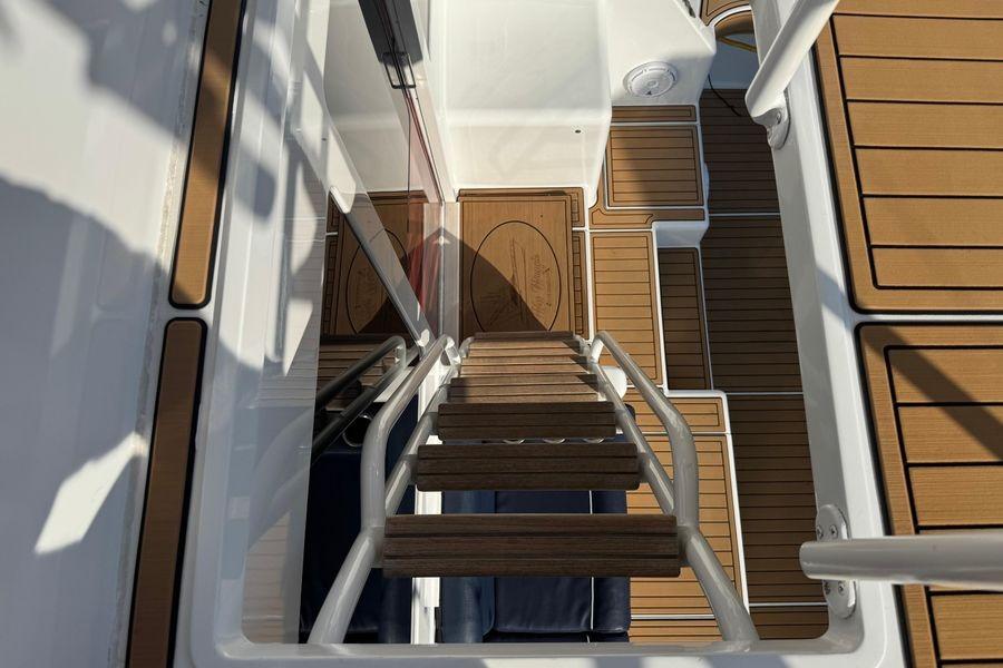 Staircase view on 2002 Viking 61 Enclosed Bridge yacht with teak flooring.