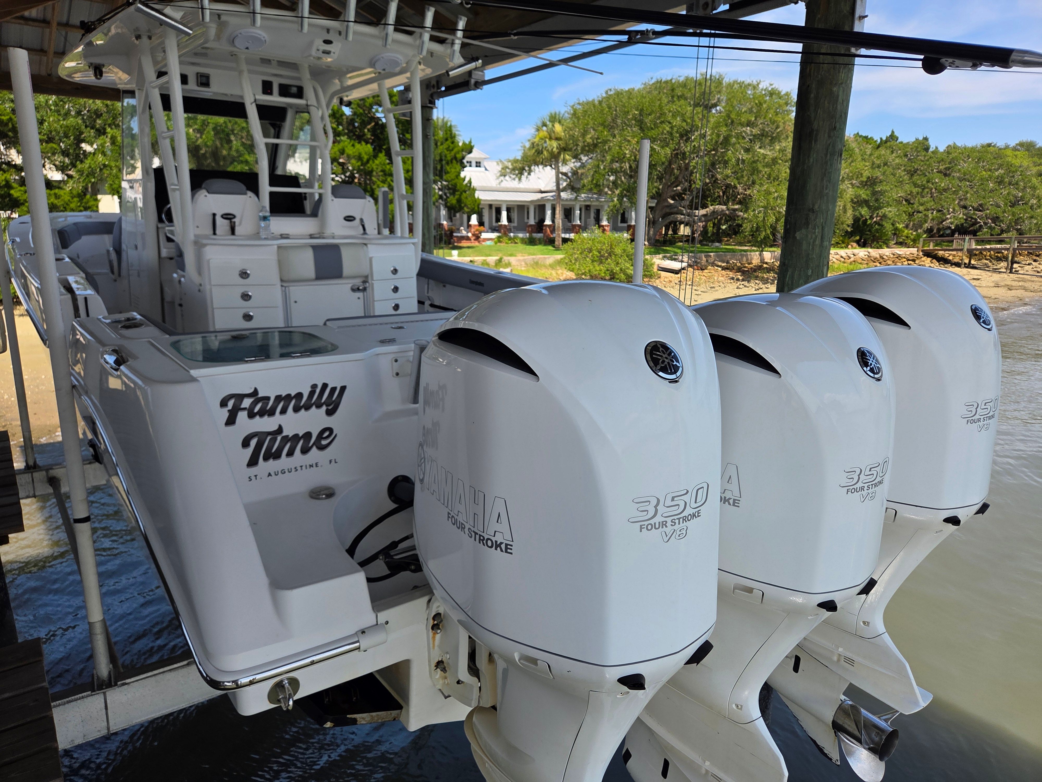 A 2017 Everglades 355 Center Console boat with three Yamaha outboard engines at the stern.