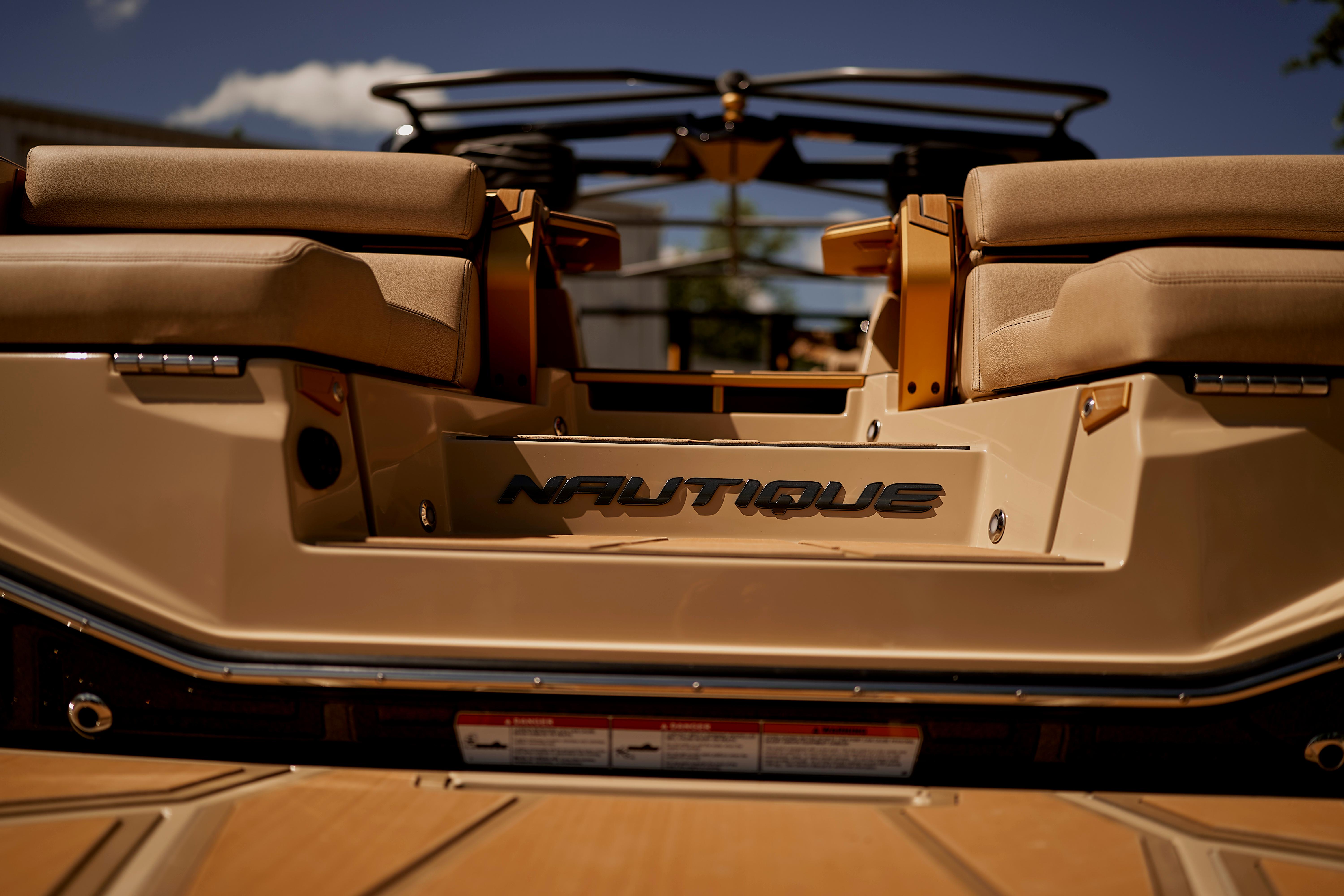 2025 Nautique Super Air Nautique G25 Paragon boat, rear view, luxurious seating, sunny day.