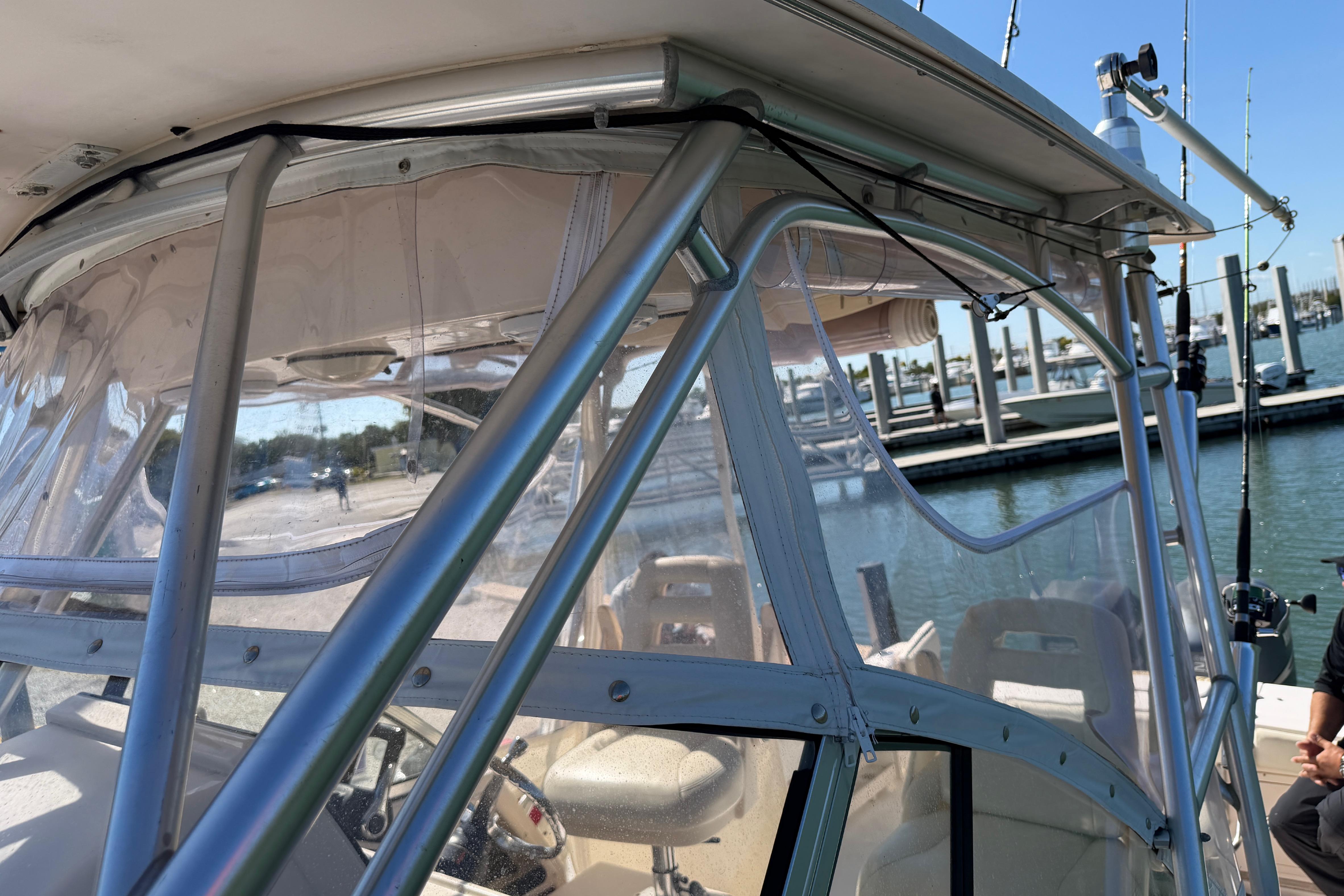 2006 Grady-White Sailfish 282 boat with clear enclosure at marina.