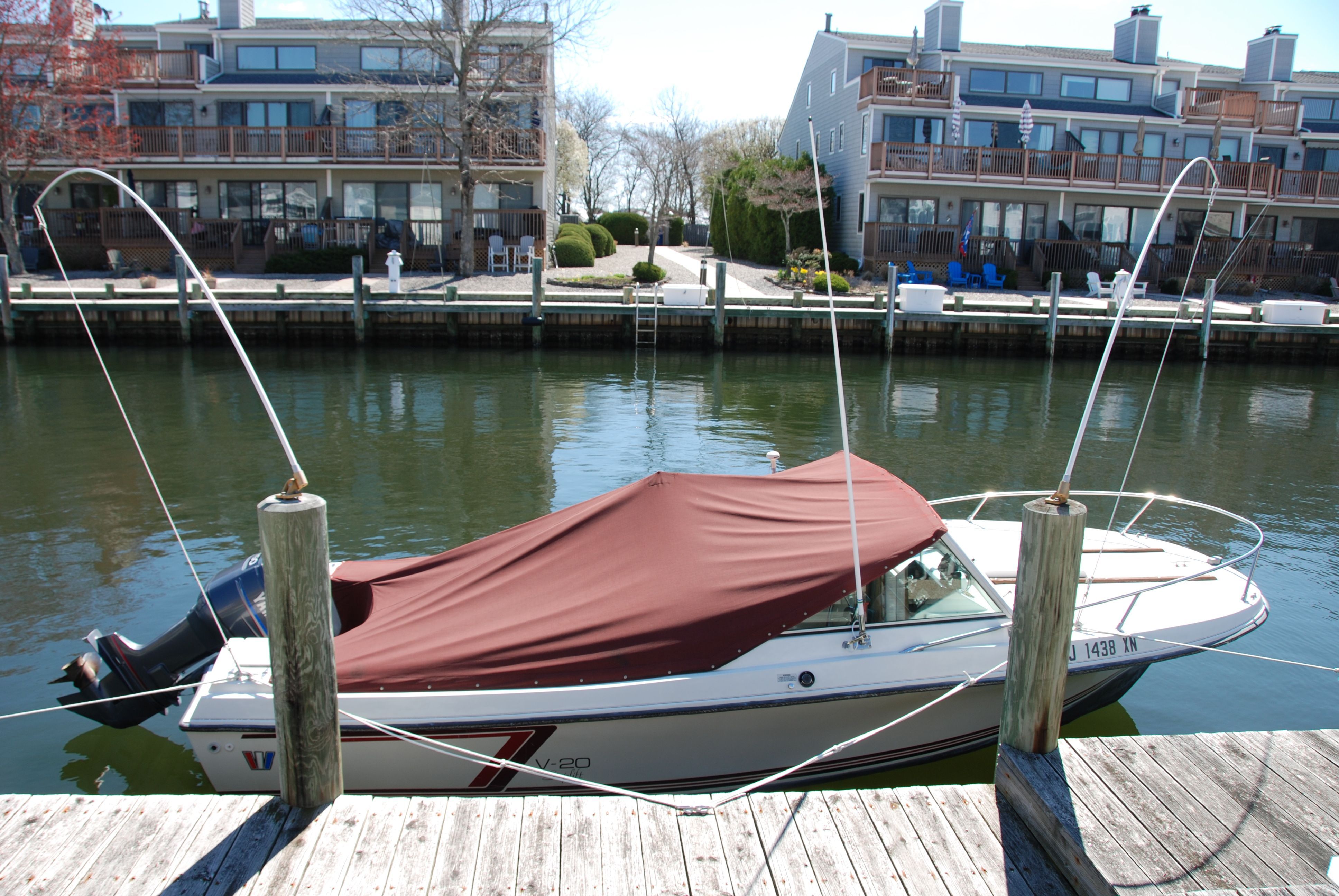 A 1987 Wellcraft V-20 Steplift boat docked in a calm harbor.