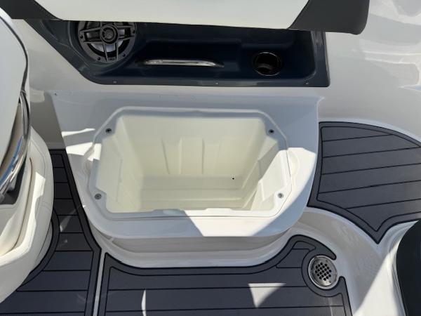 2023 Chaparral 267 SSX boat deck with storage compartment and speaker.