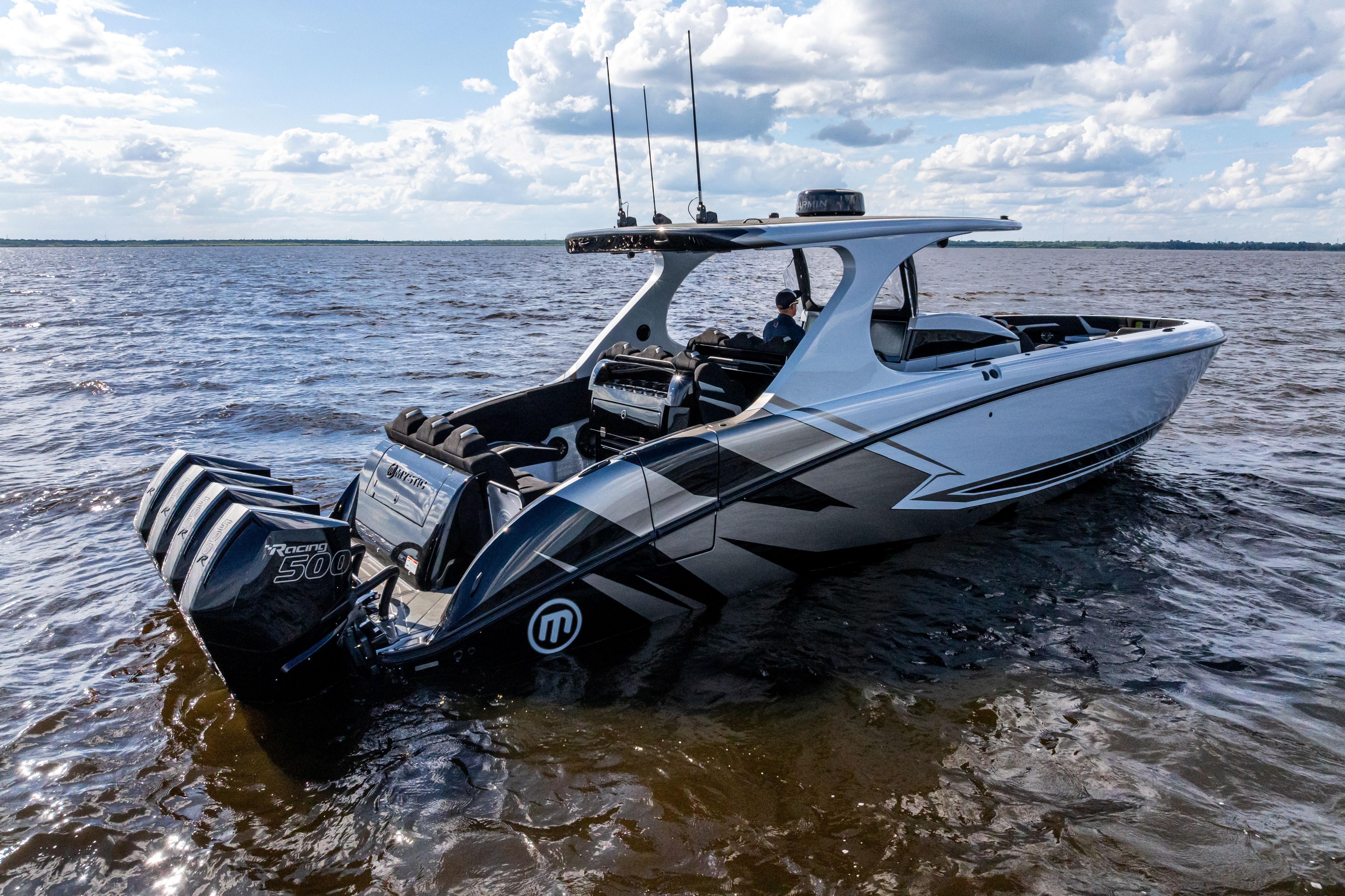 2027 Mystic Powerboats M4200 on water, featuring sleek design and powerful engines.