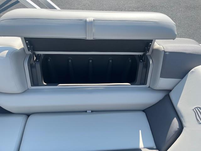 Open storage compartment on 2026 Sun Tracker Fishin' Barge 20 DLX boat seat.