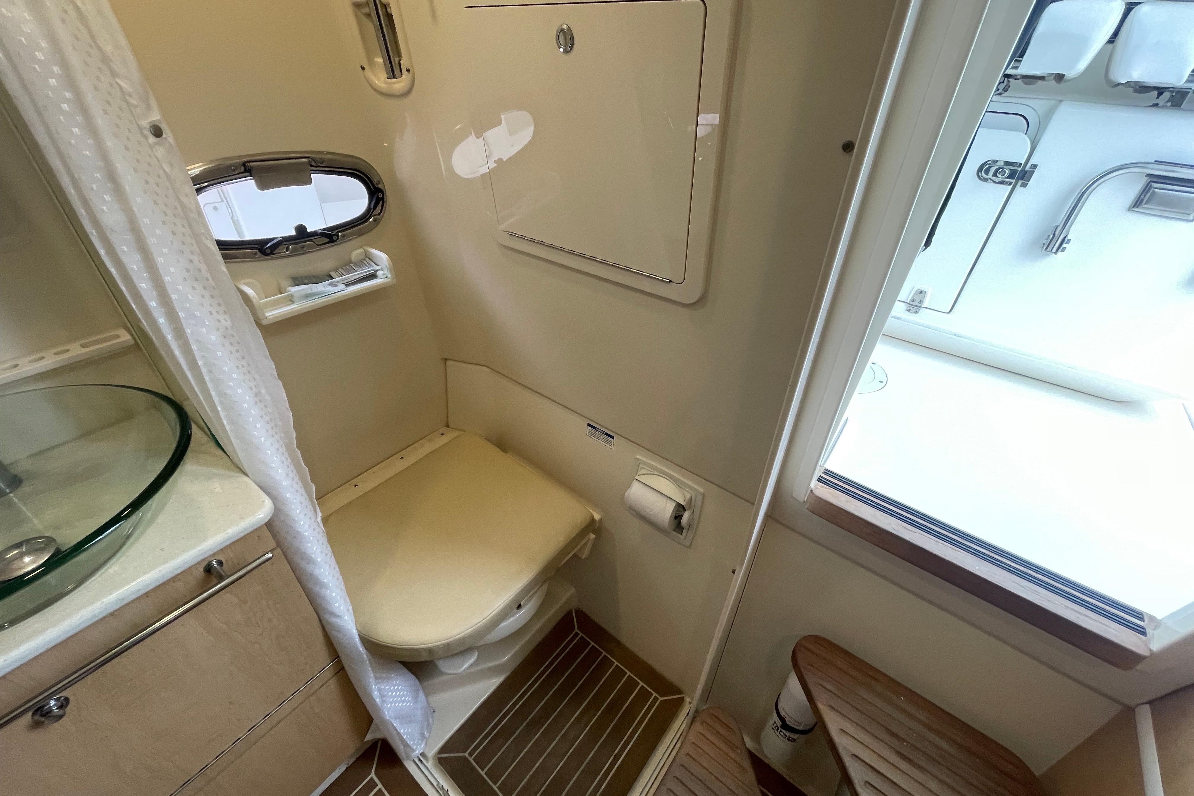 Interior of 2015 Boston Whaler 370 Outrage boat bathroom with toilet and sink.