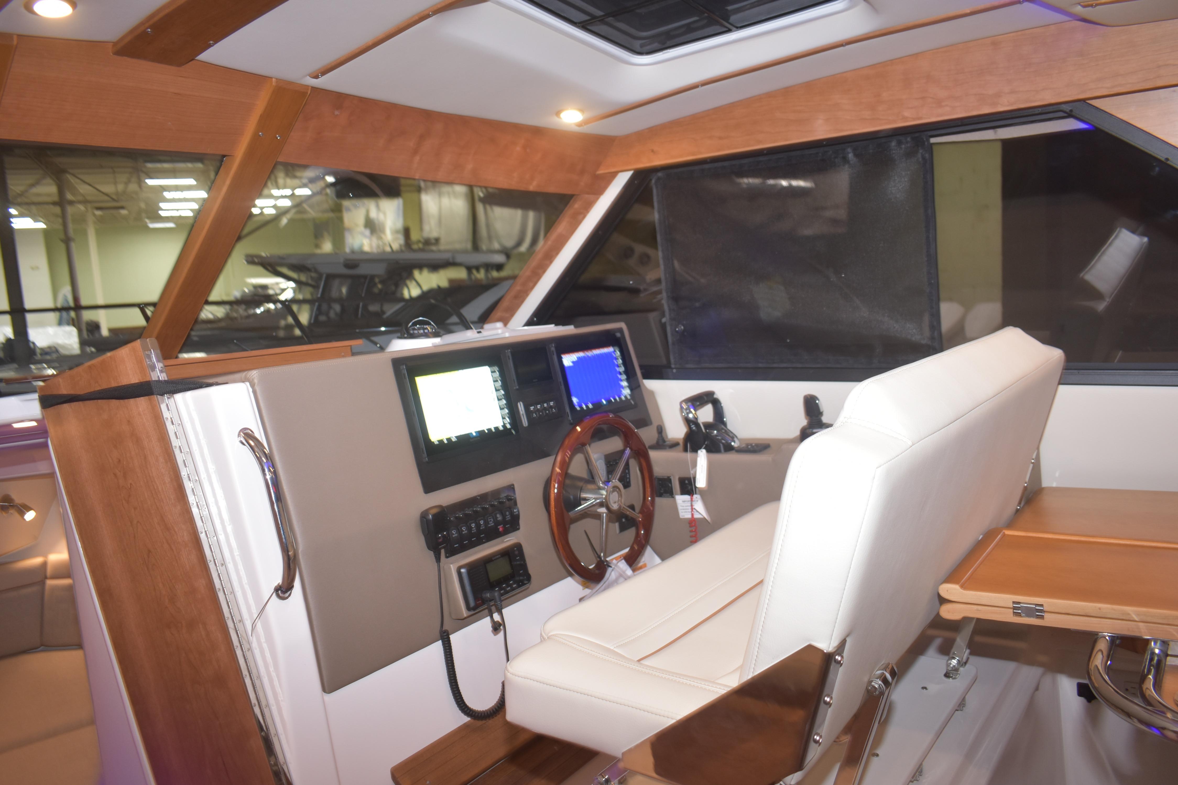 Interior of 2026 Cutwater C-32 CB boat with modern helm and seating.