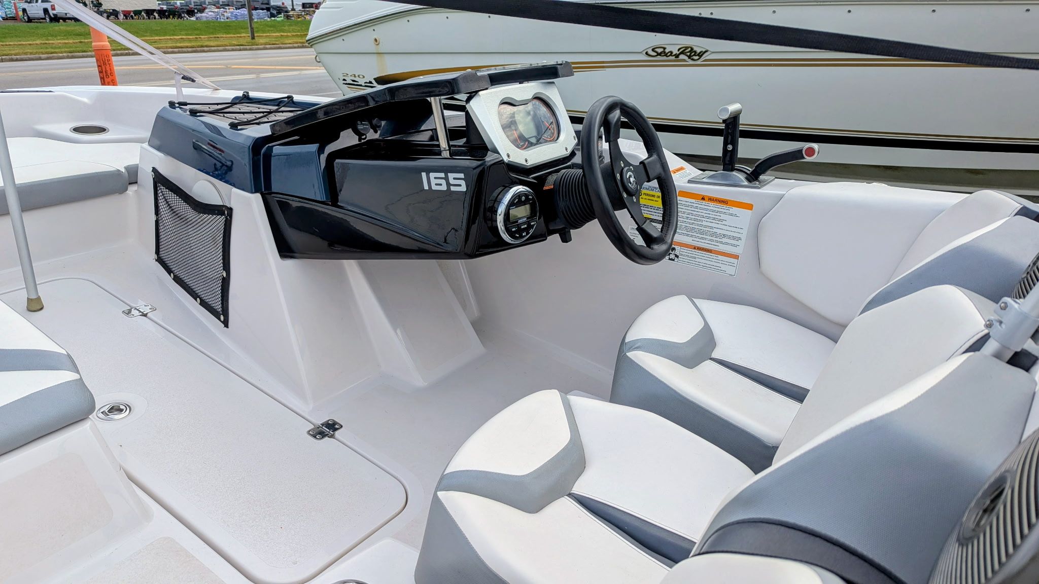 Interior of a 2017 Scarab 165 H.O. boat with steering console.