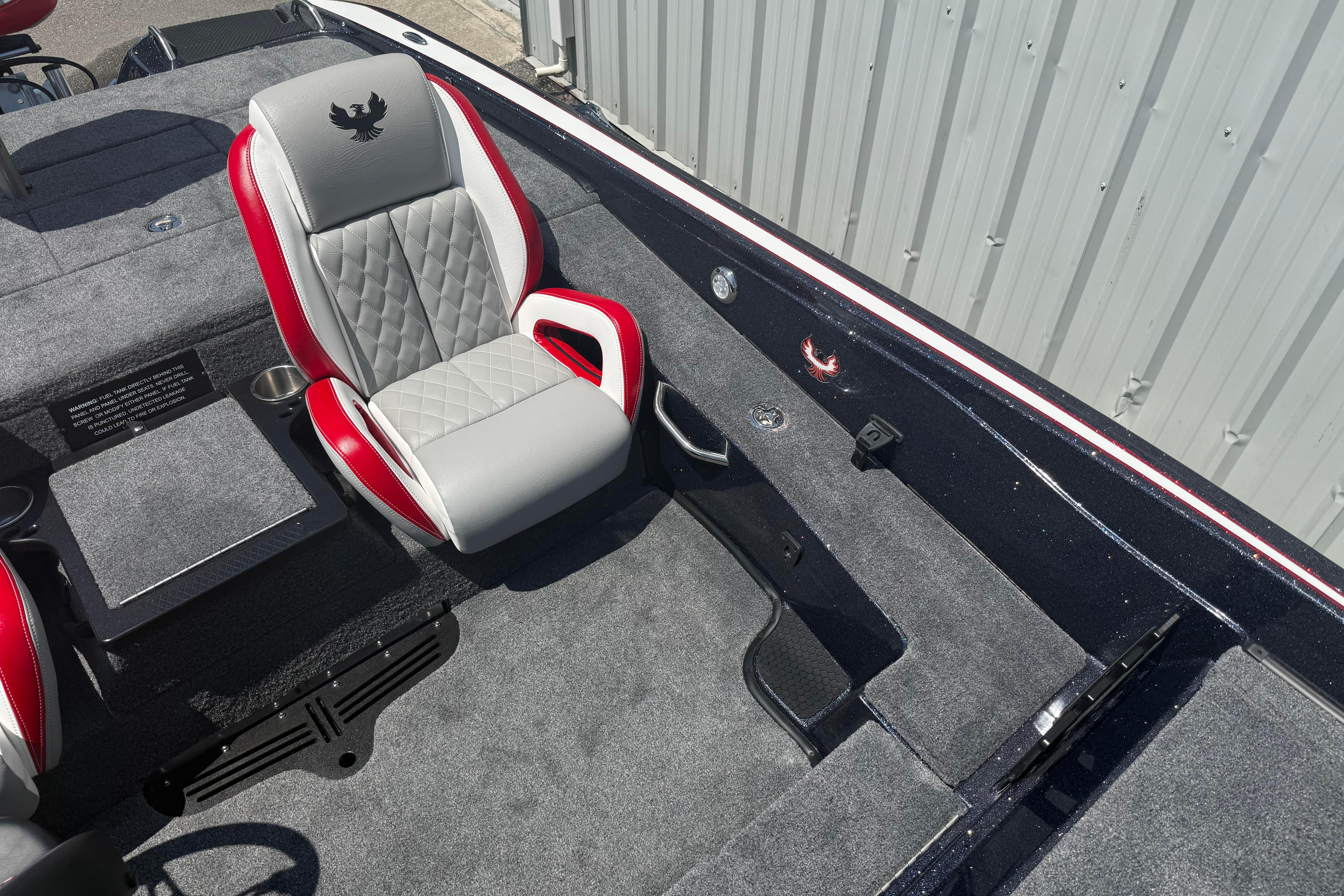 Interior of 2027 Phoenix 819 ZXL boat with red and gray seating.