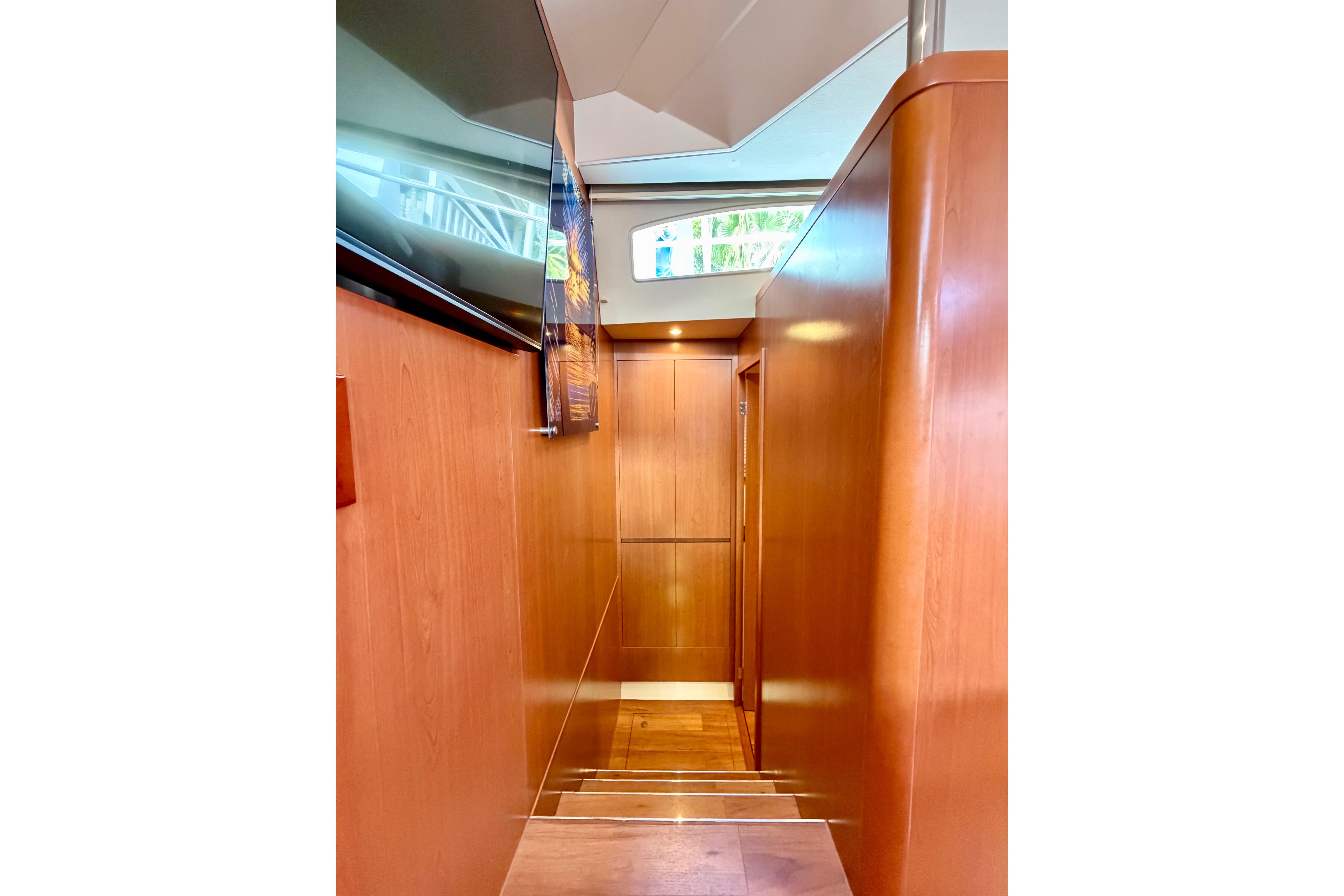 Interior hallway of 2017 Aquila 44 Yacht with wooden paneling and modern design.