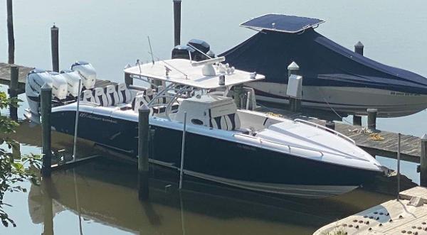 2019 Midnight Express 39 Cuddy boat docked, featuring sleek design and powerful engines.