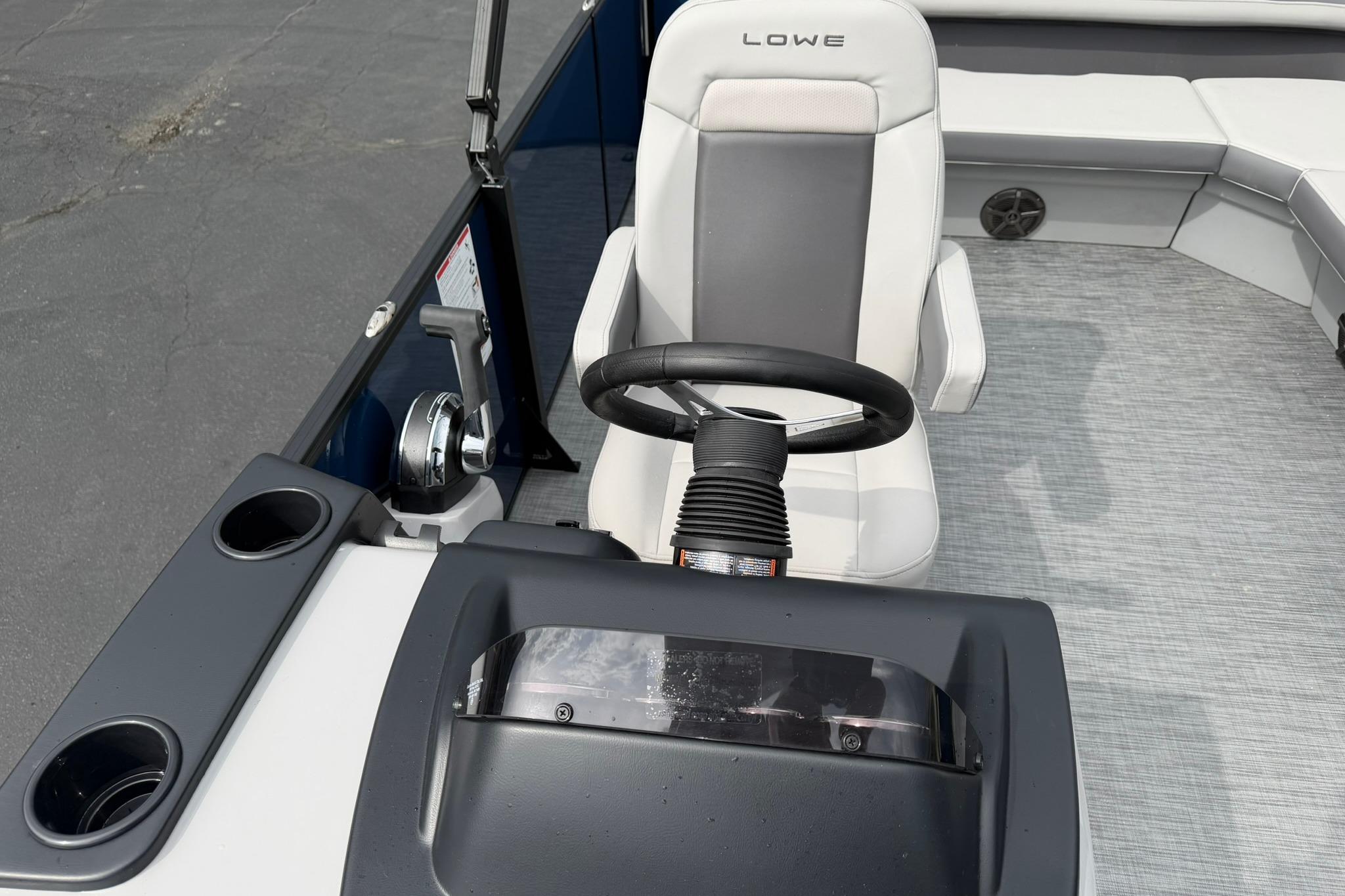 Steering console of 2026 Lowe LS 190 boat with comfortable seating.