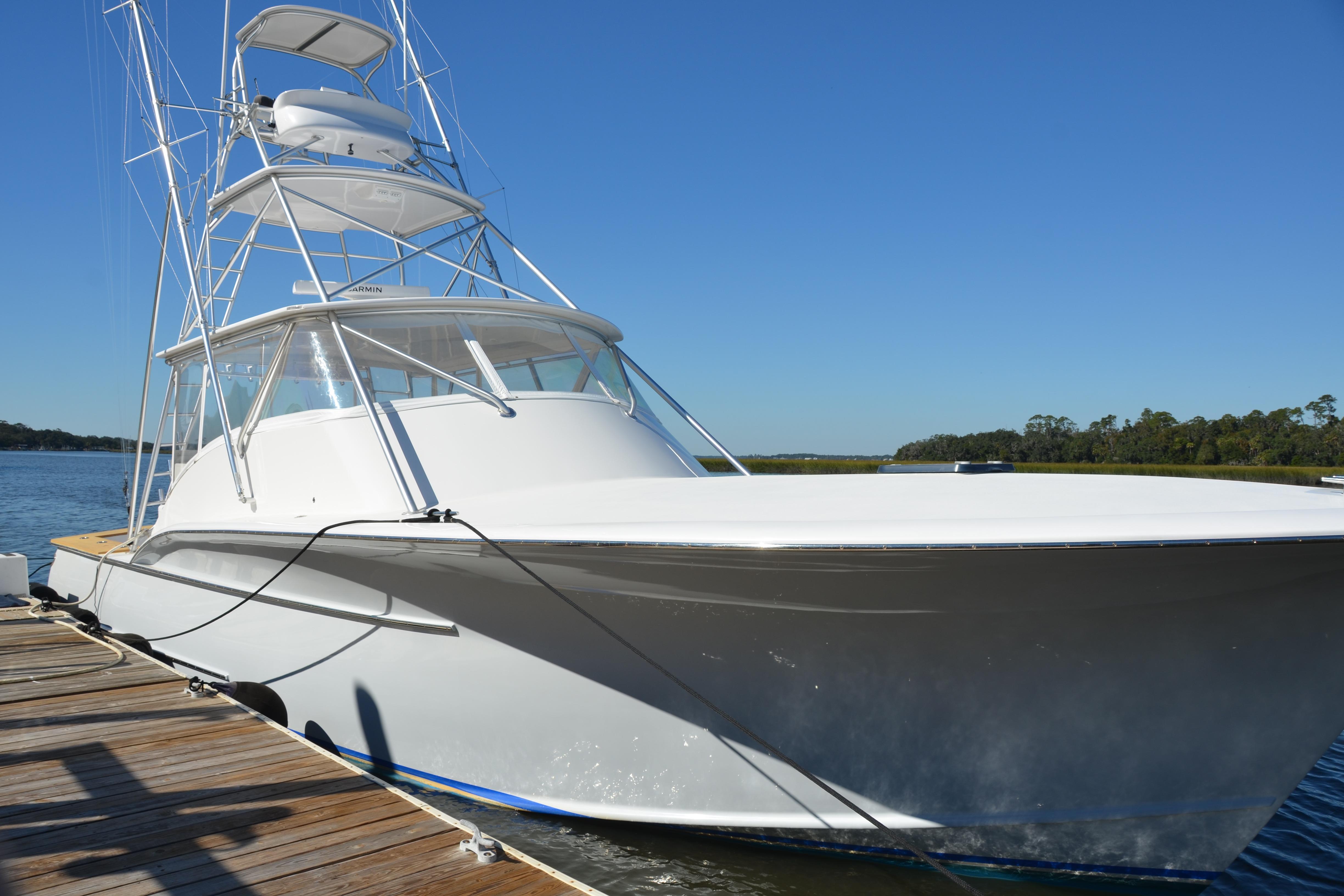 2006 Custom Carolina Heritage Express boat docked on a sunny day.