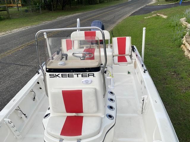 2012 Skeeter ZX200 boat with red and white seats on a road.