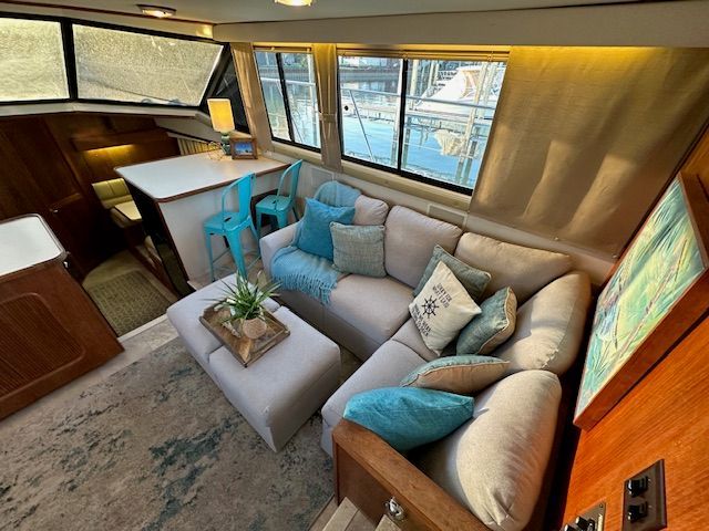 Interior of Carver 3807 yacht with cozy sofa and blue accents.