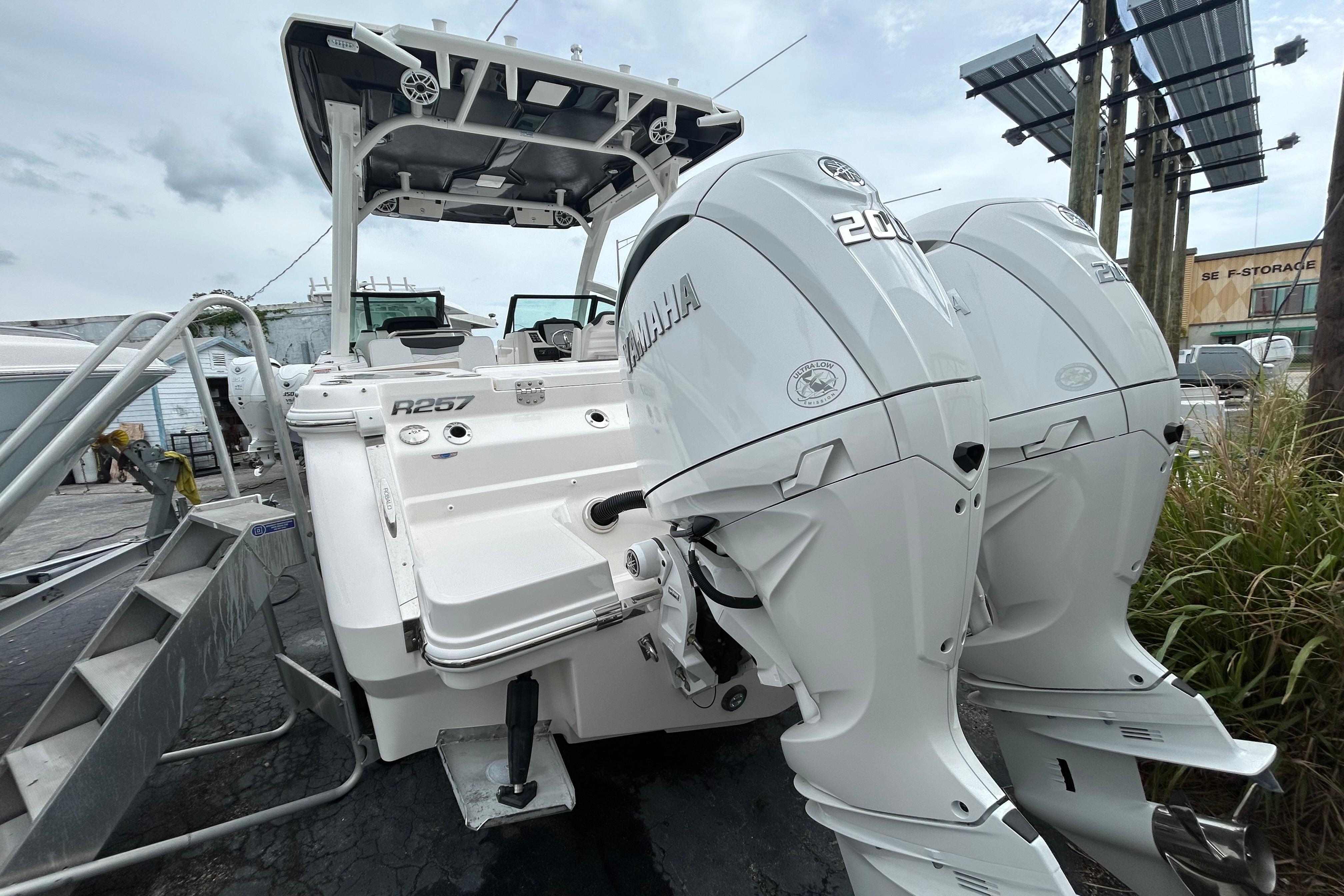 2026 Robalo R257 Dual Console boat with twin Yamaha 200 engines, docked outdoors.