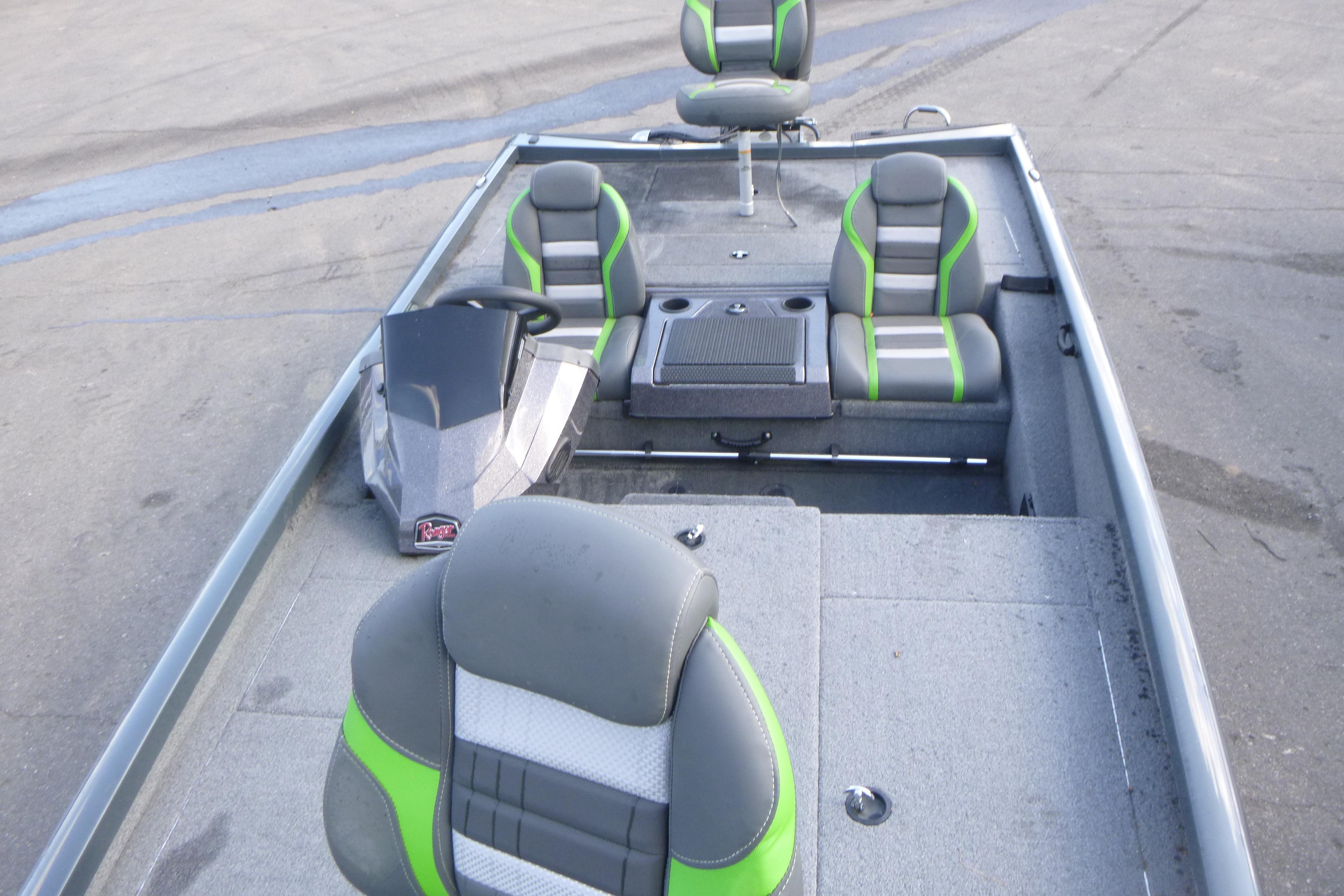 2023 Ranger RT198P boat interior with gray and green seating, steering console, and storage compartments.