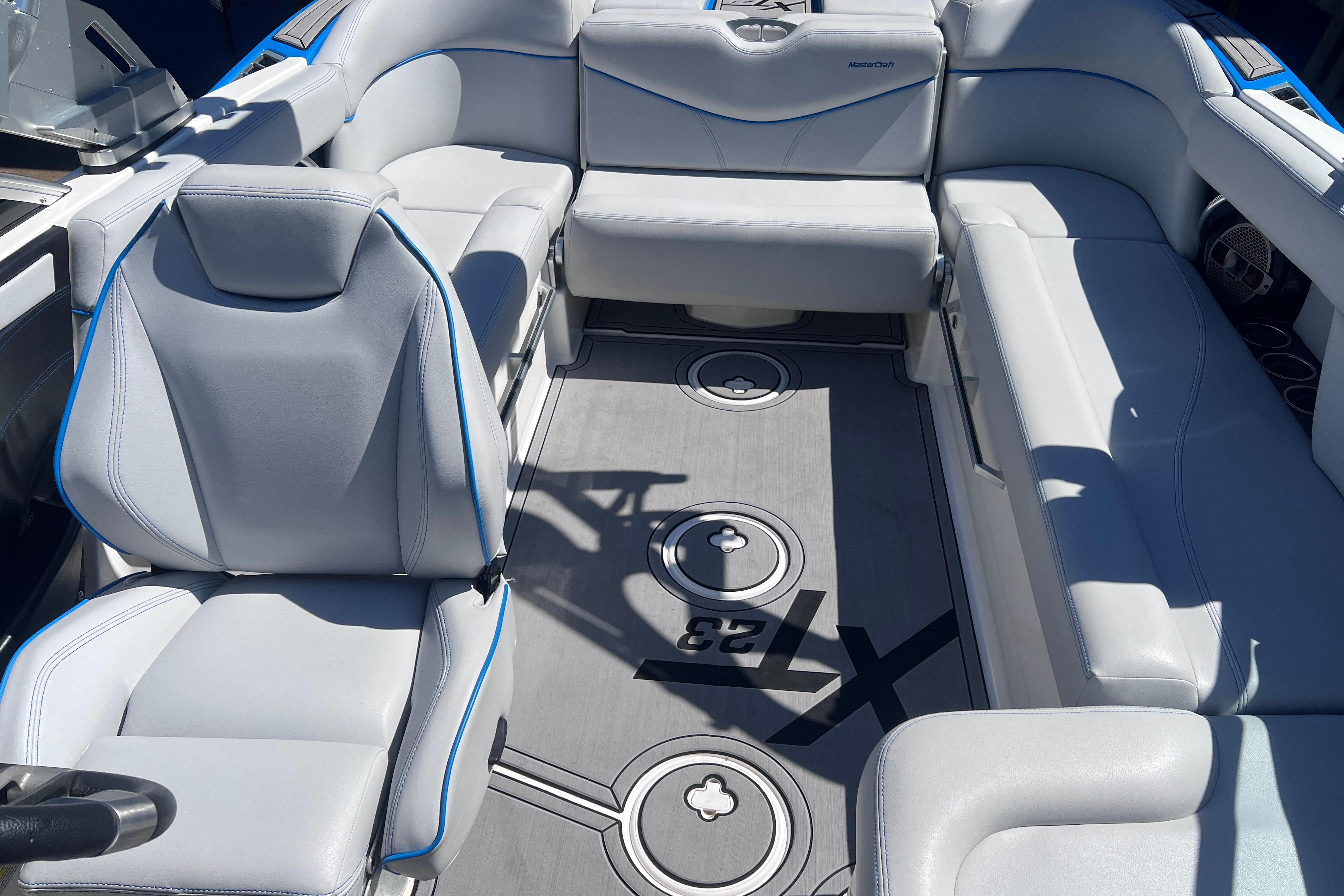 Luxurious interior of 2021 MasterCraft XT23 boat with sleek seating and modern design.