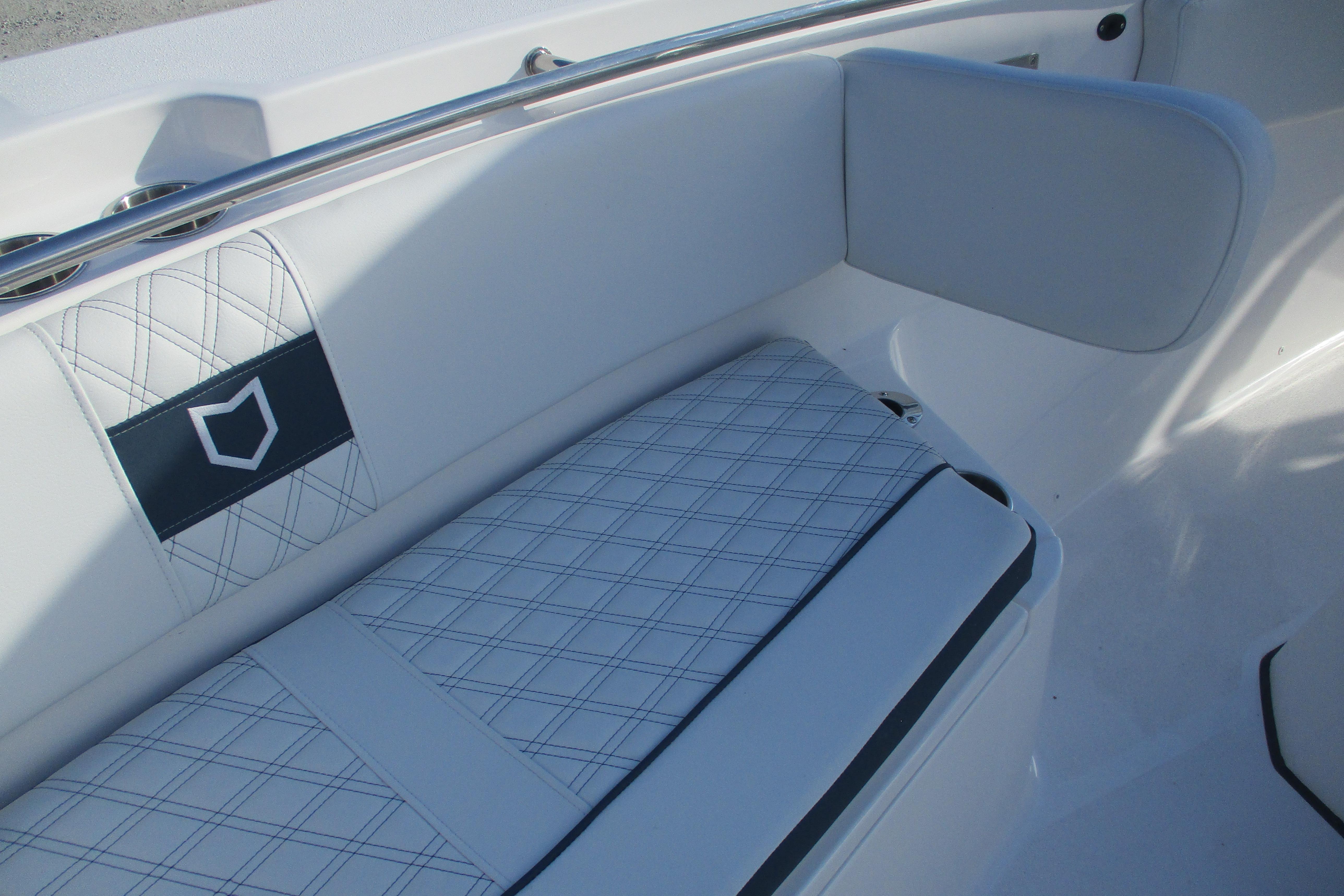 2026 Sea Fox 328 Commander boat interior with white cushioned seating.