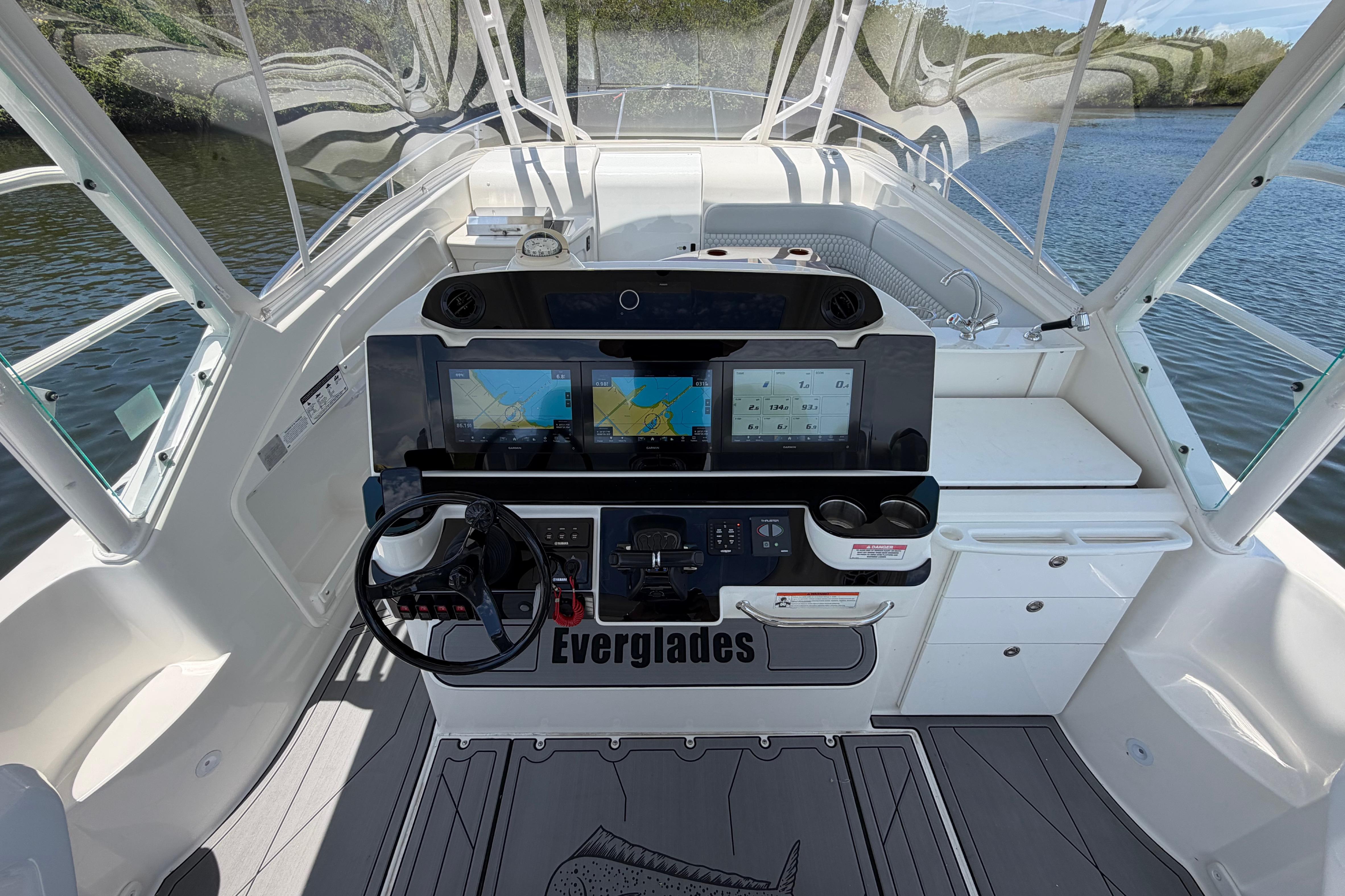 Cockpit of 2009 Everglades 350LX boat with navigation screens and steering wheel.