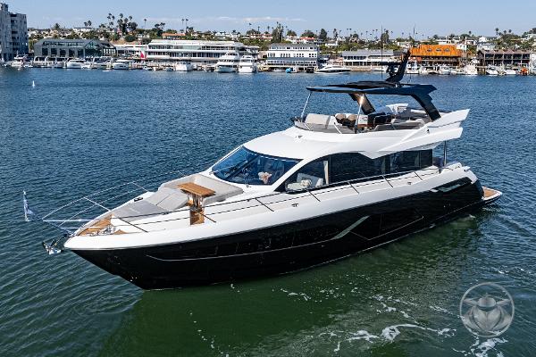 2025 Sunseeker Manhattan 68 luxury yacht cruising in a scenic marina.