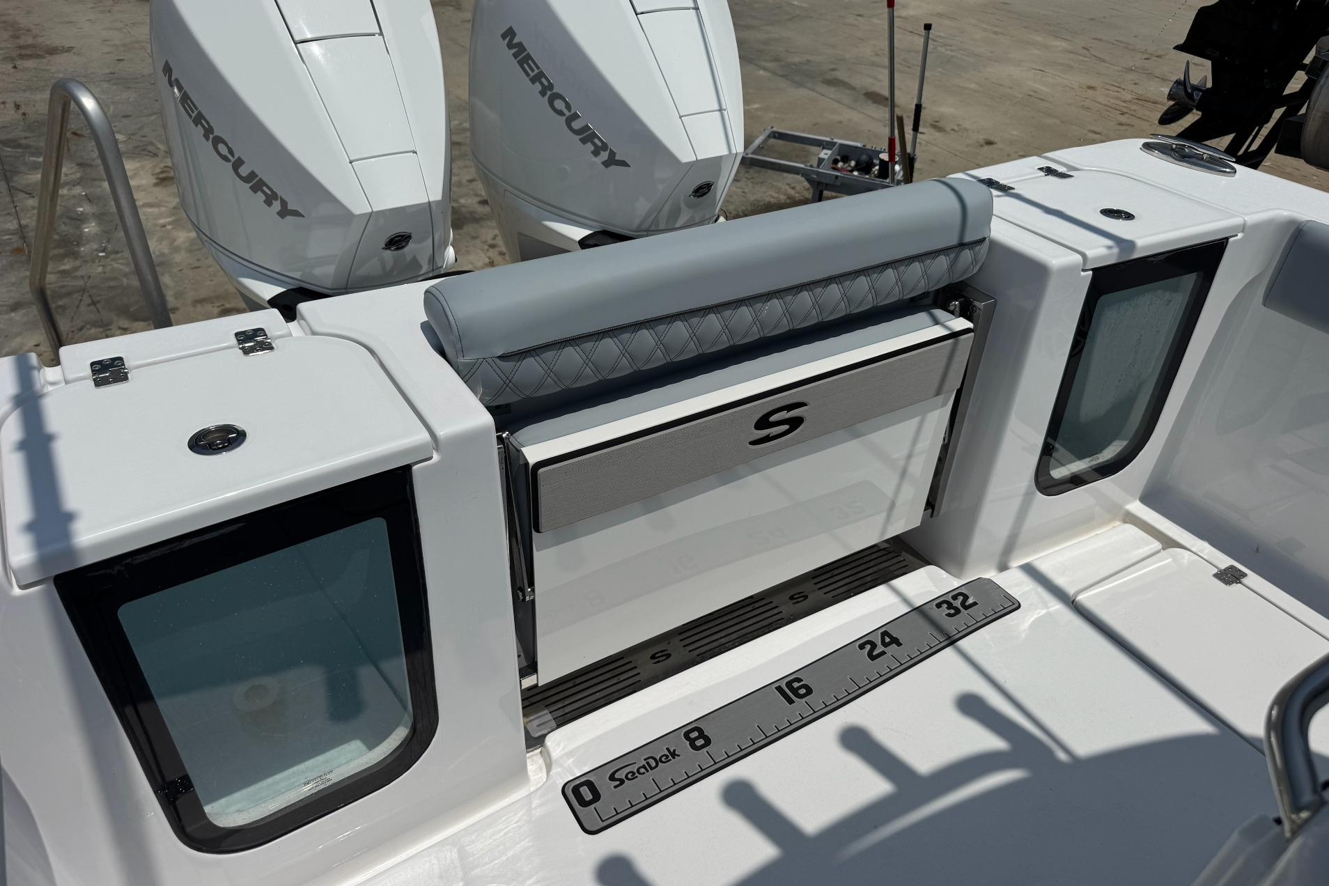 2026 Sportsman Open 262 Center Console boat with dual Mercury engines and fishing ruler.