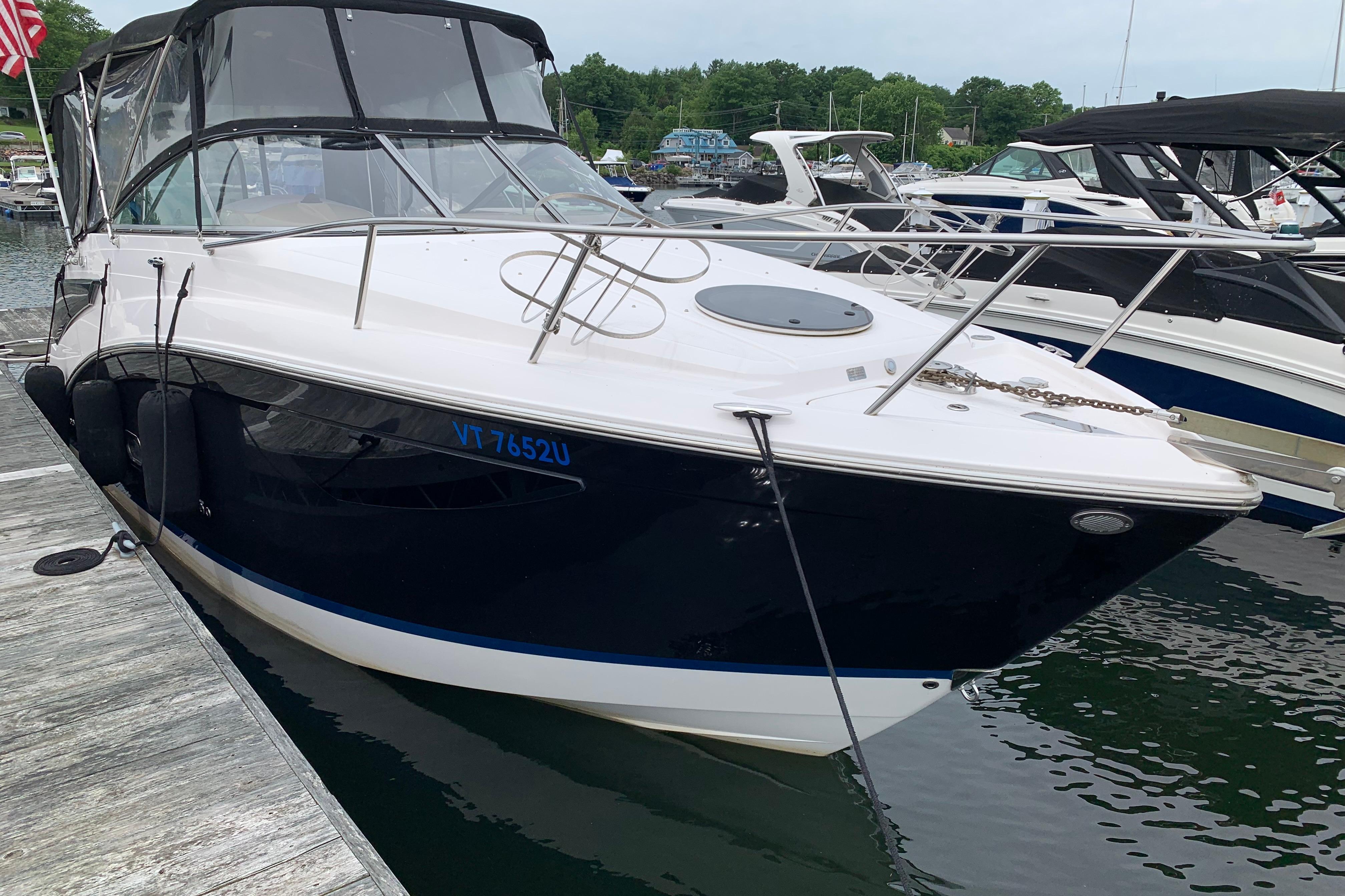 2017 Regal 26 Express boat docked at marina, featuring sleek design and black hull.