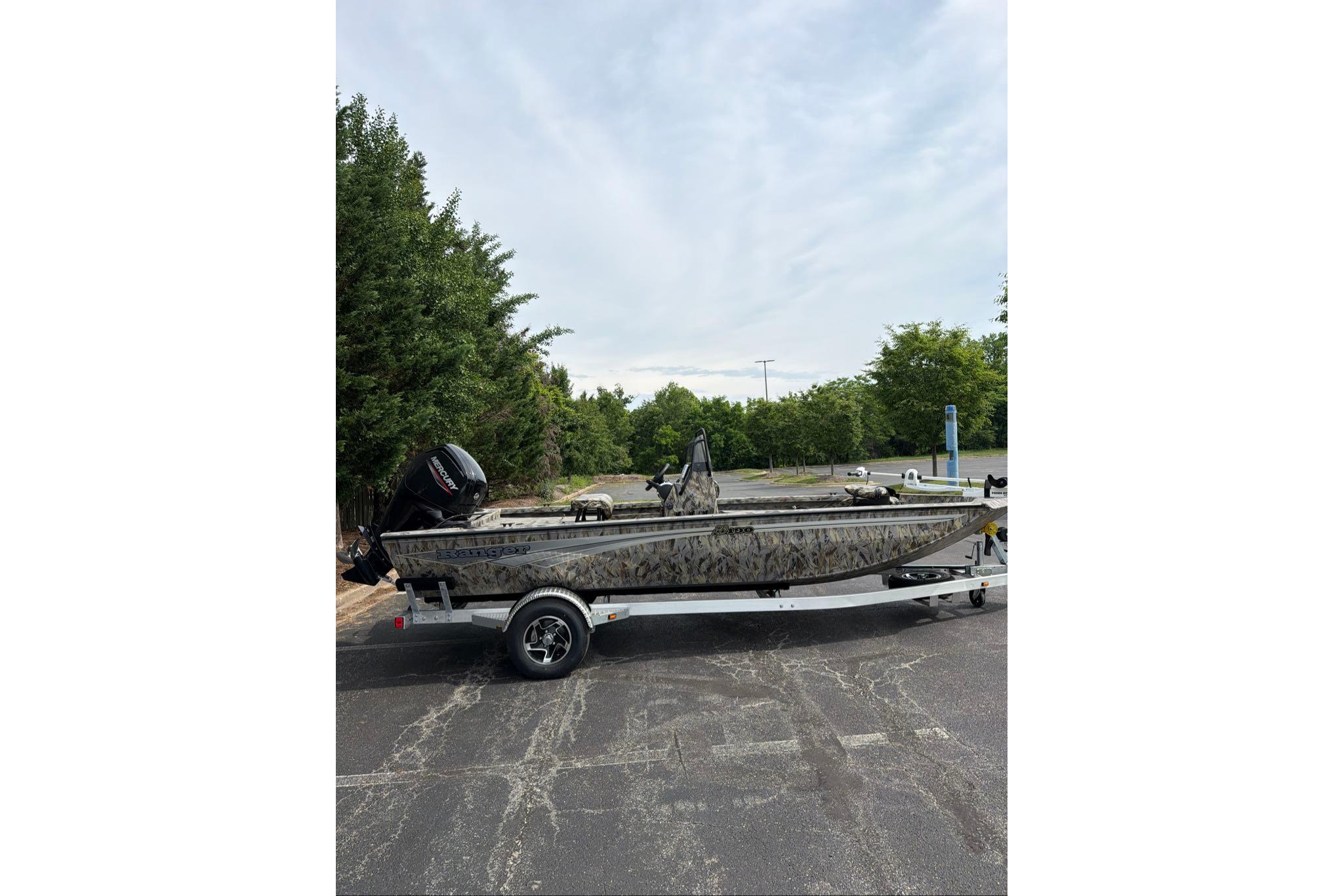2026 Ranger RB190 boat on trailer, parked outdoors with trees in background.