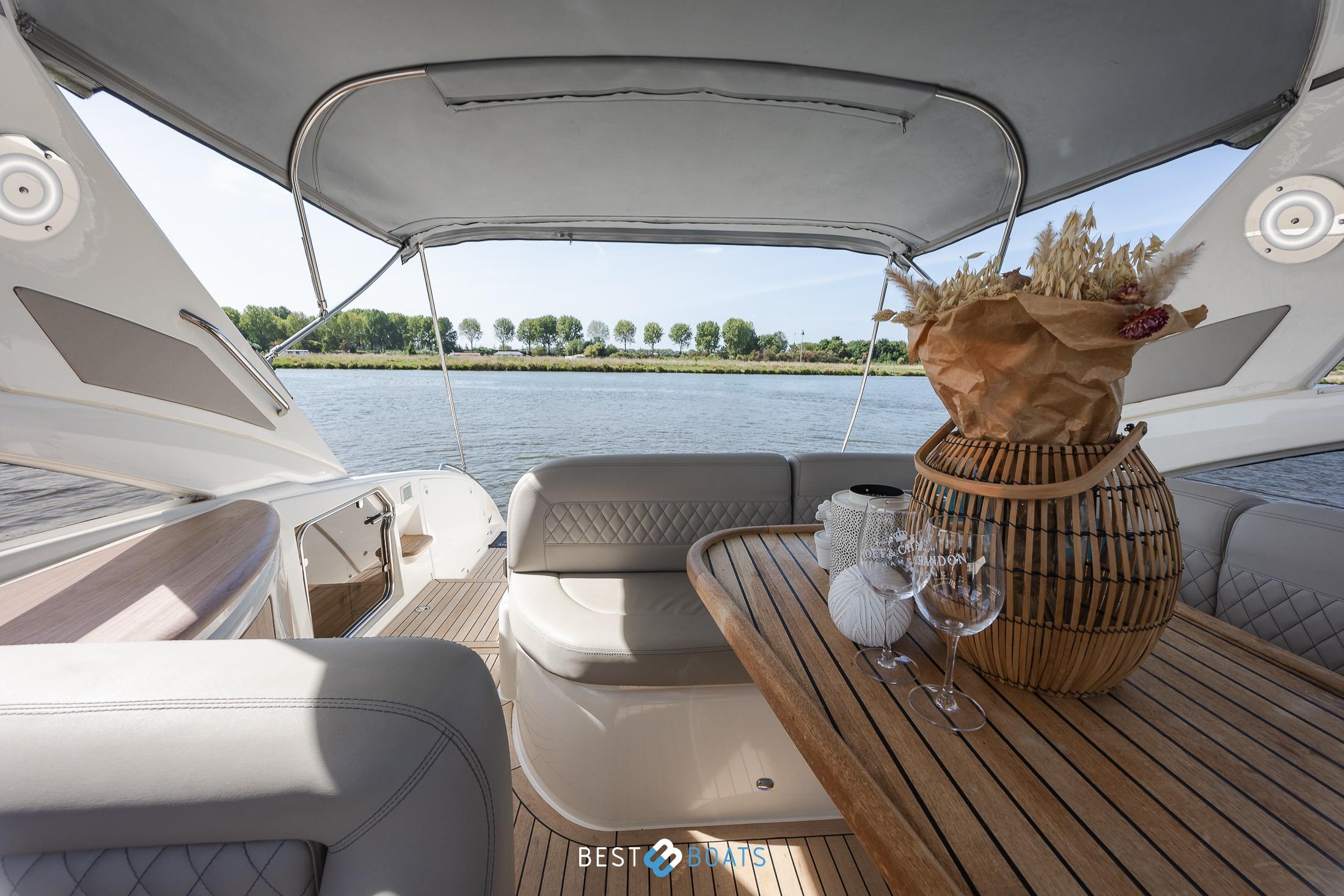 Luxurious 2006 Princess V42 yacht interior with elegant seating and scenic water view.