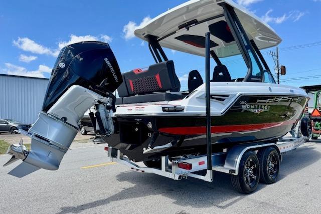 2026 Monterey Elite 25 OB boat on trailer, featuring sleek design and powerful outboard motor.
