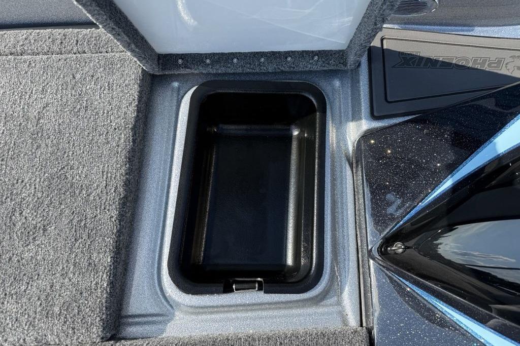 Storage compartment in 2026 Phoenix 20 XE boat, featuring carpeted interior and sleek design.