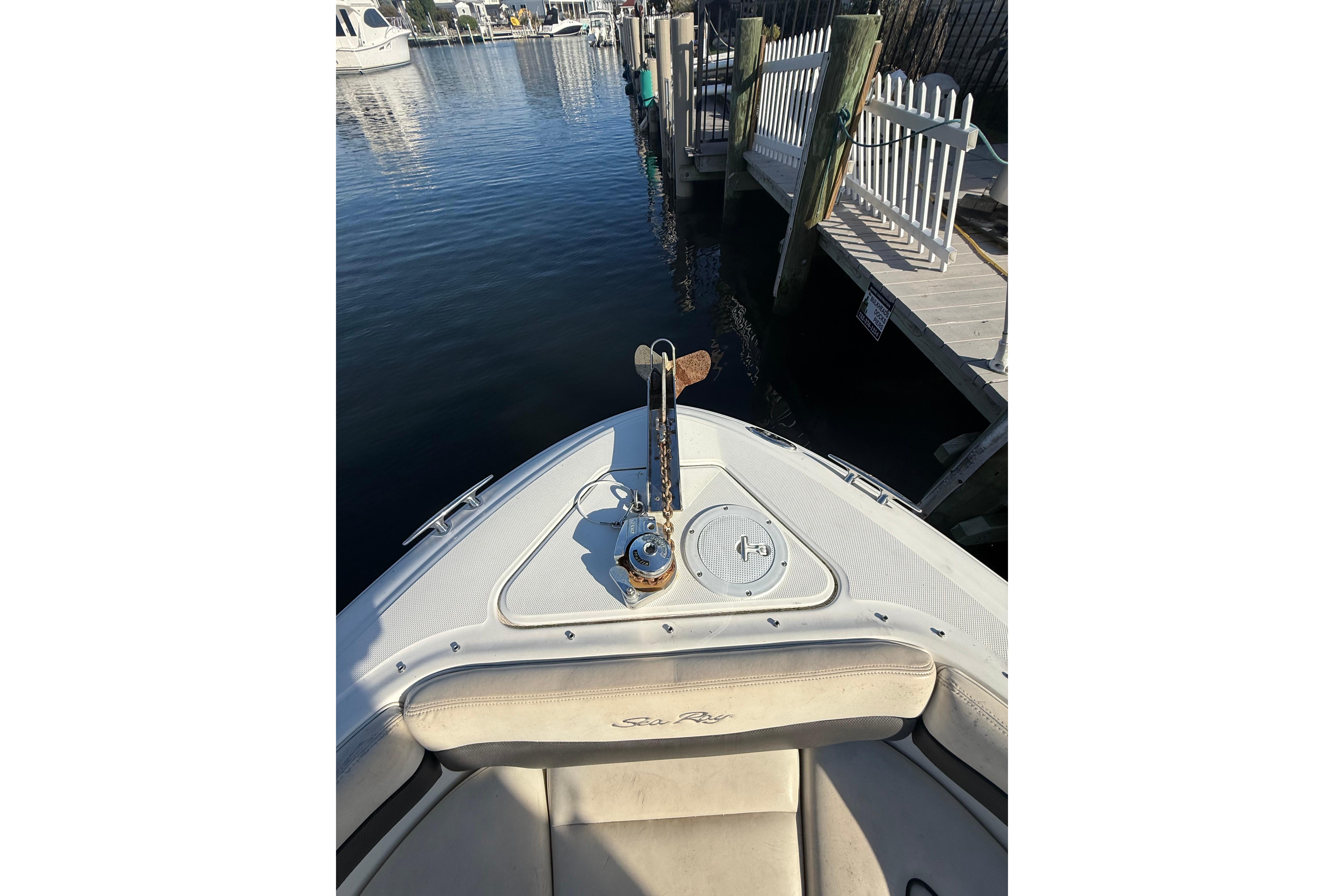 2005 Sea Ray 290 SLX boat docked at marina, showing bow and anchor.