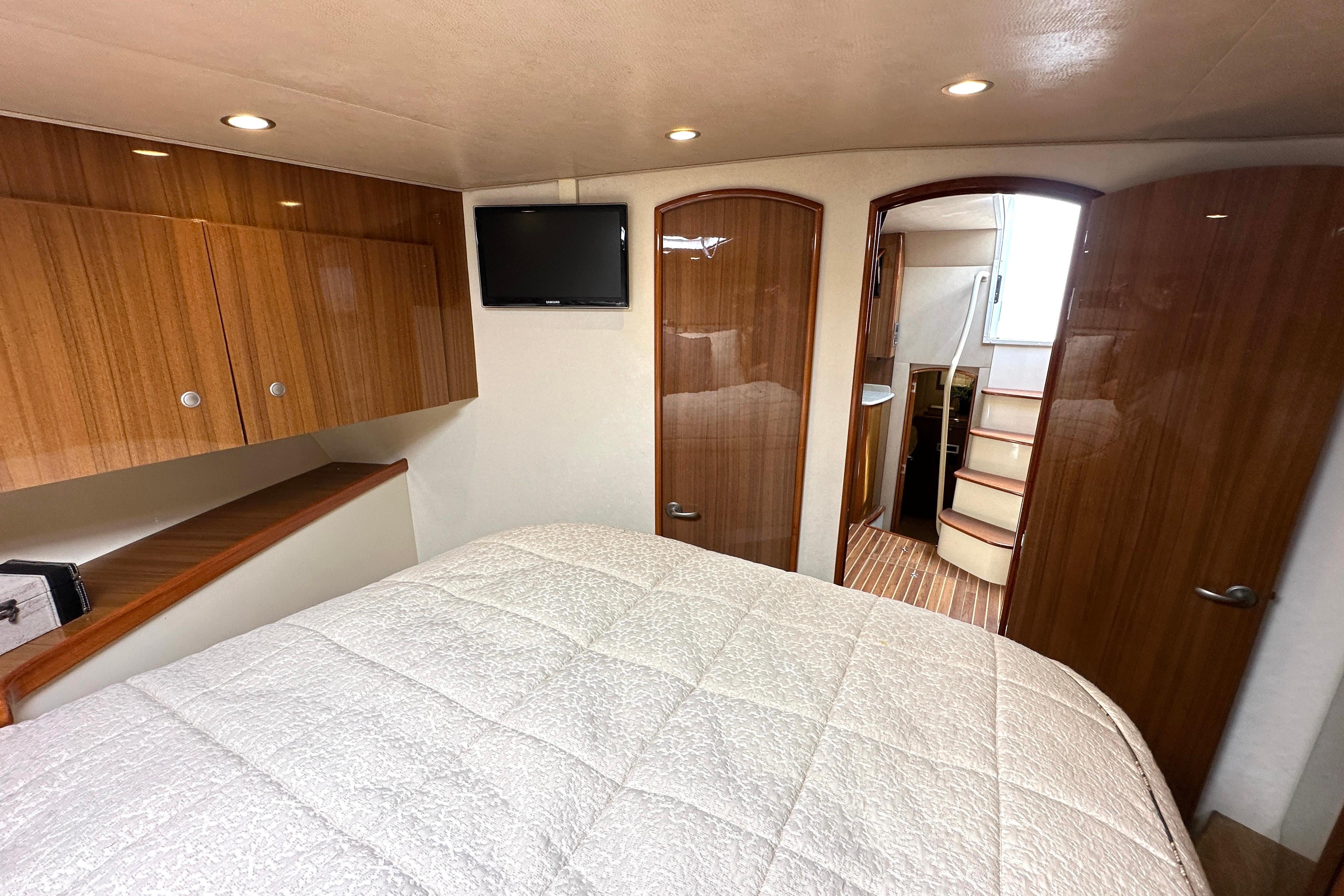 Luxurious interior of 2012 Viking 42 Open yacht with cozy bedroom and modern amenities.